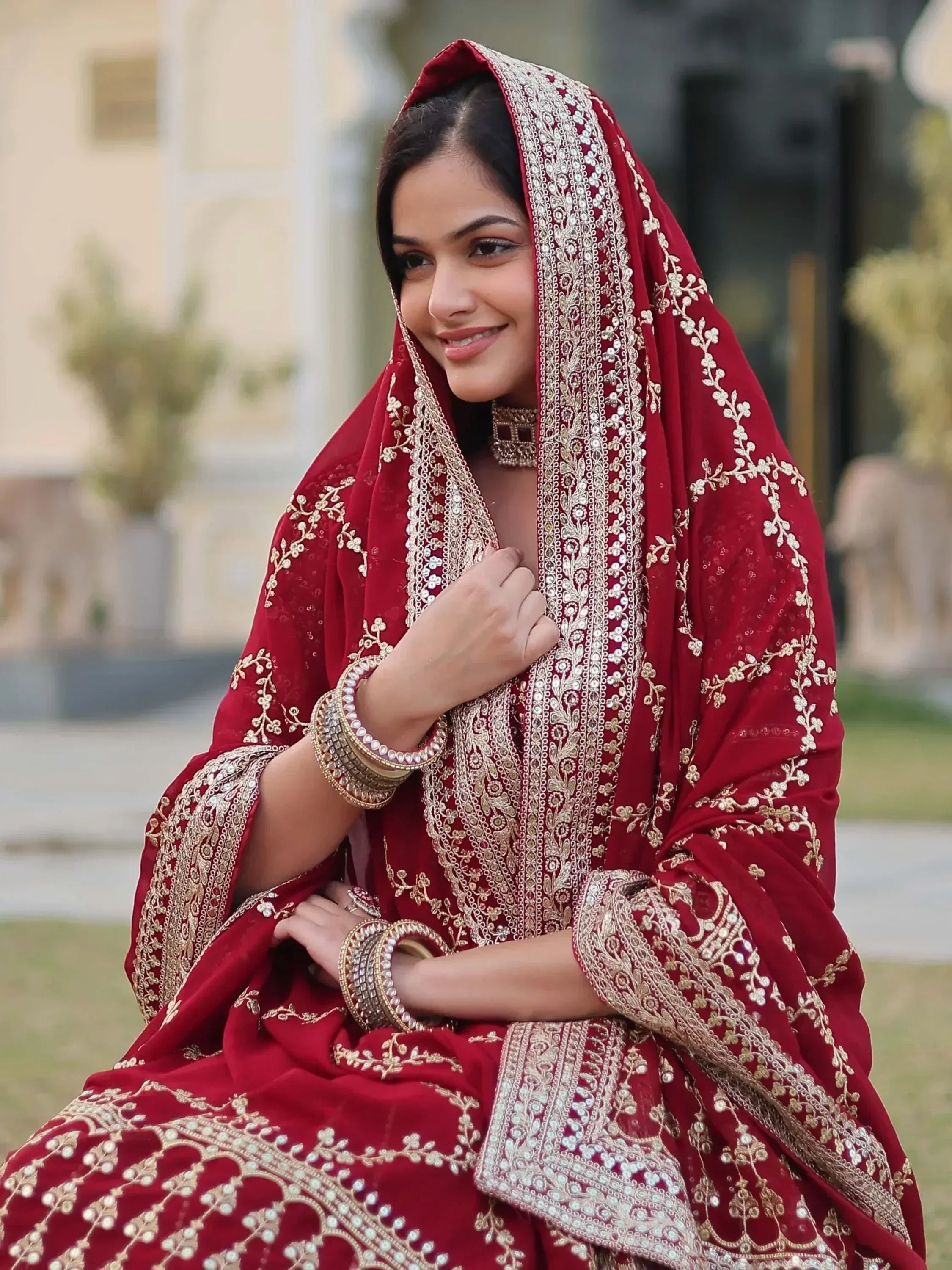 Red embroidered Indian bridal lehenga choli with gold detailing and matching dupatta