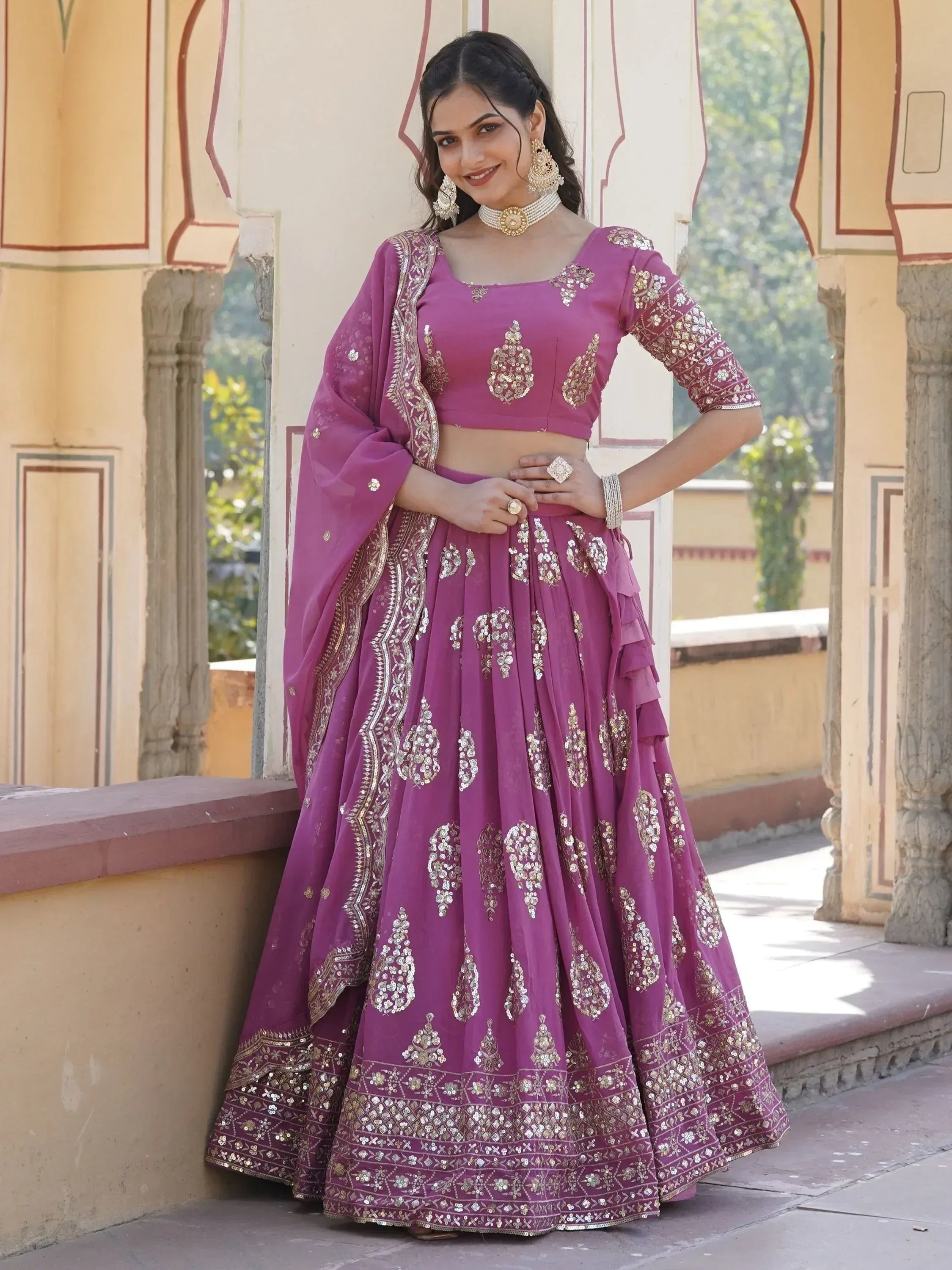 Purple designer lehenga choli with gold embroidery, perfect for Indian weddings and festive occasions