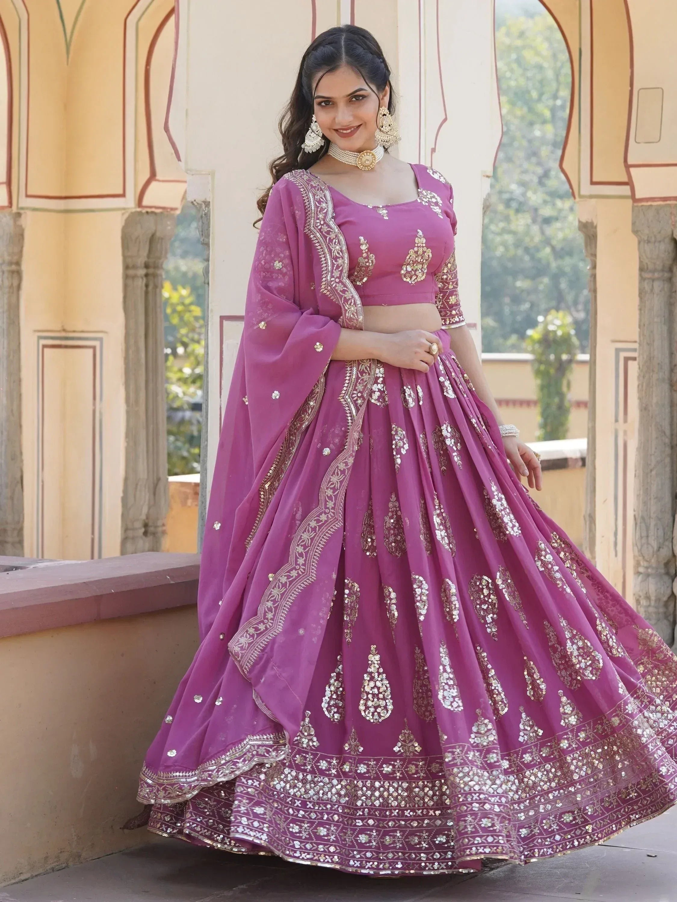 Elegant purple lehenga choli with gold embroidery, perfect for Indian weddings and festive occasions.