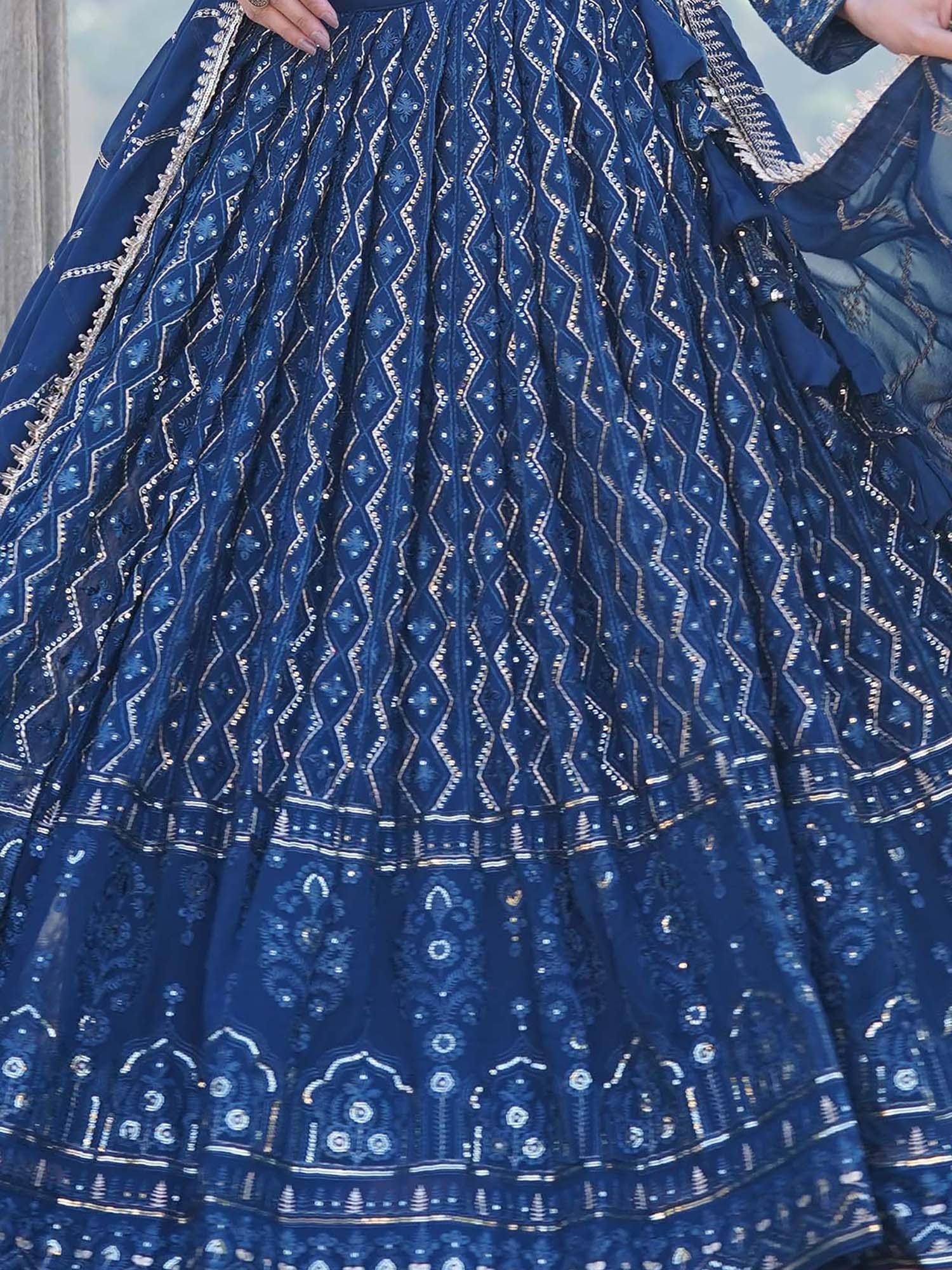 Navy blue designer lehenga choli with intricate gold embroidery and mirror work, perfect for Indian ethnic wear.