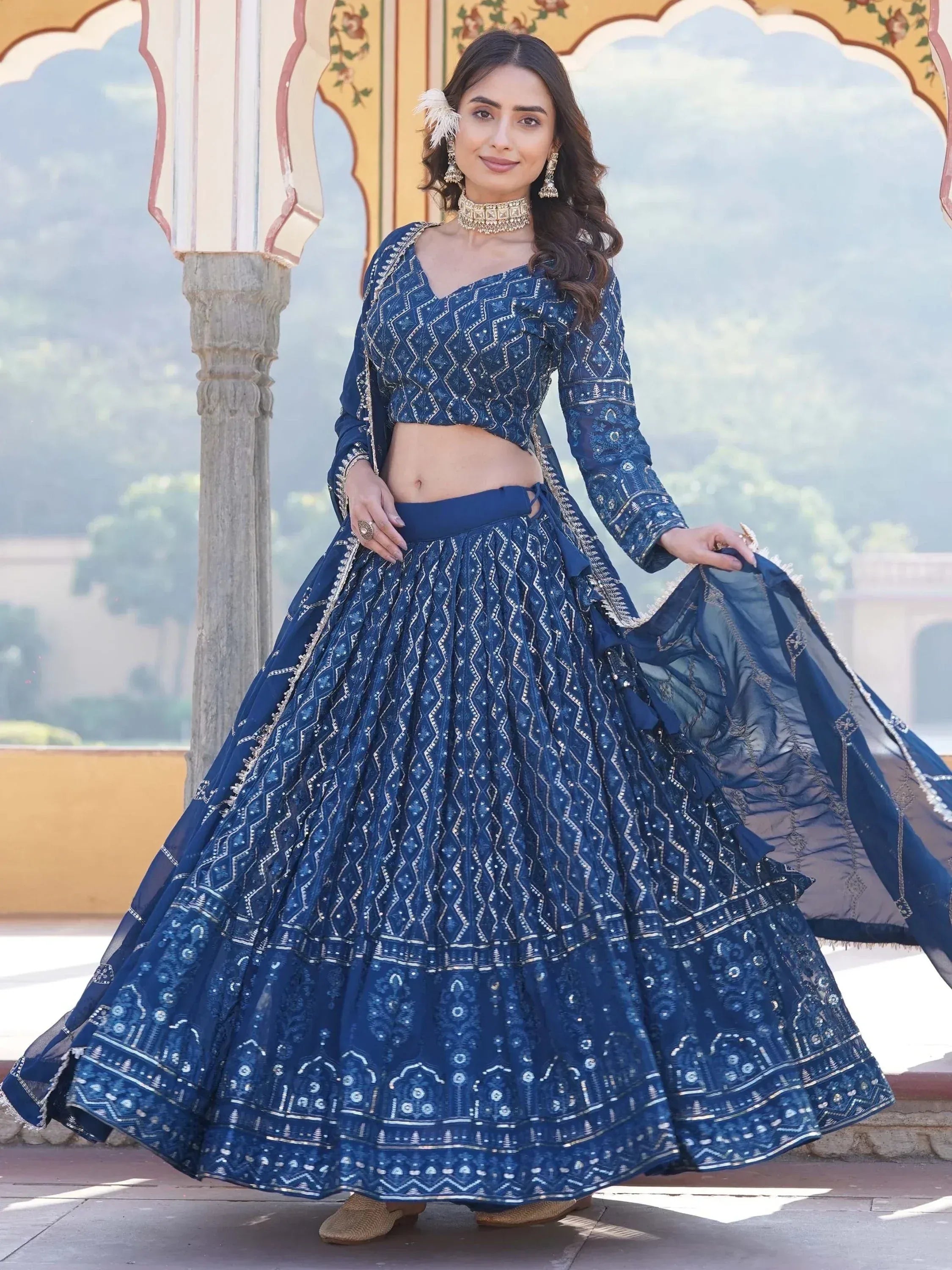 Elegant blue embroidered lehenga choli with geometric patterns, perfect for Indian ethnic wear occasions.