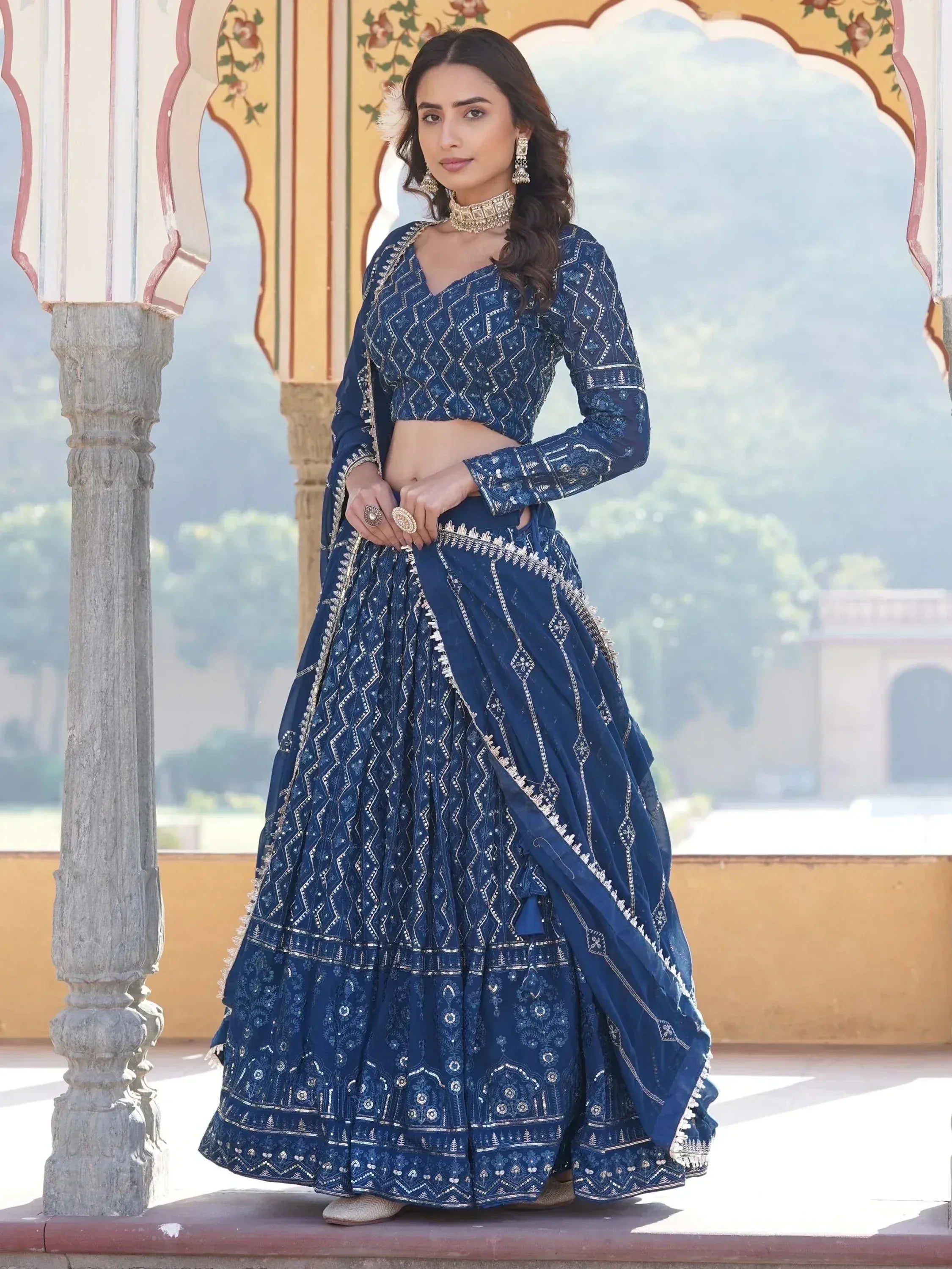 Elegant navy blue embroidered lehenga choli with gold detailing, perfect for Indian weddings and festive occasions.