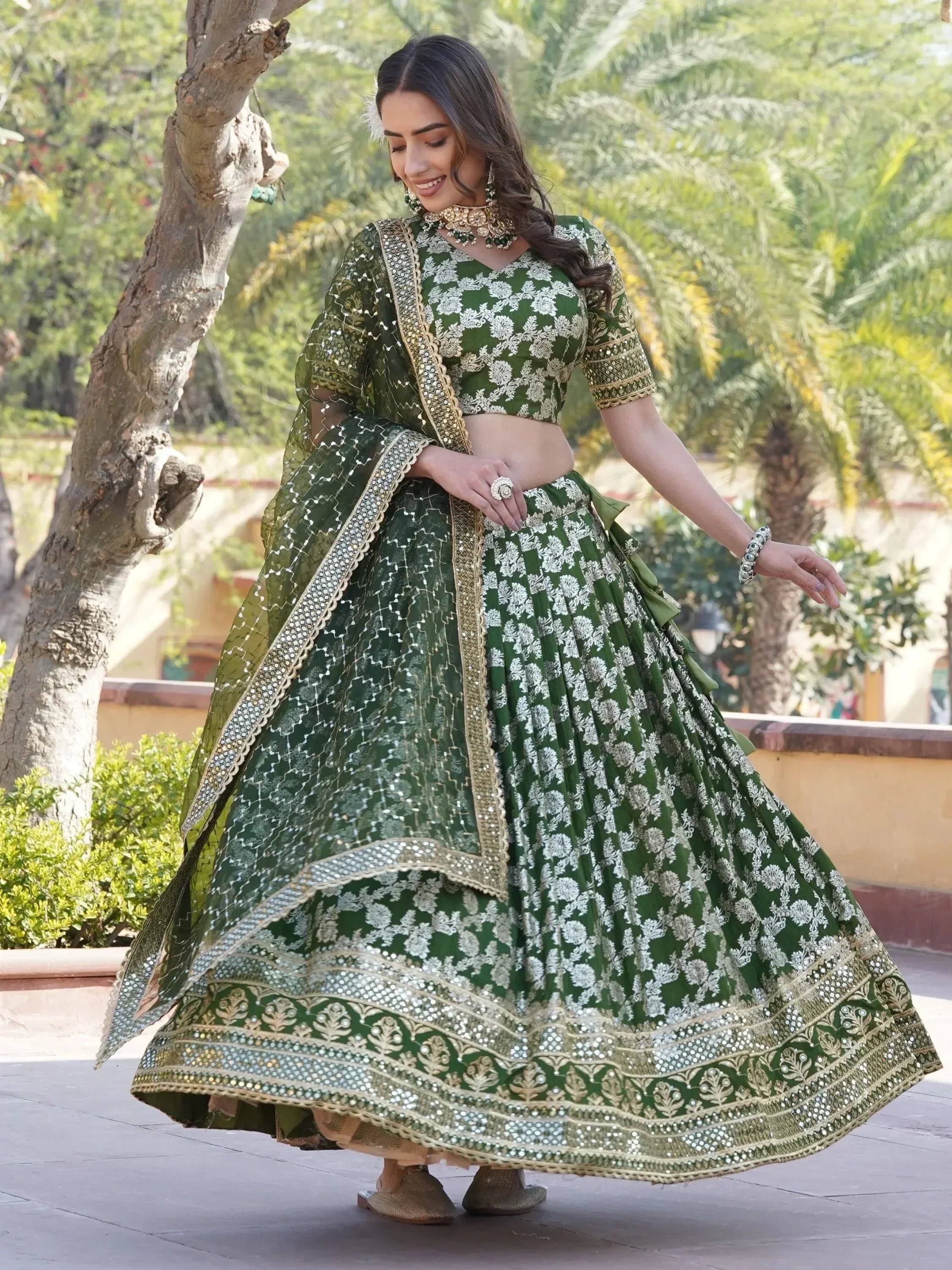 Green floral lehenga choli with gold embroidery and mirror work, perfect for Indian ethnic occasions
