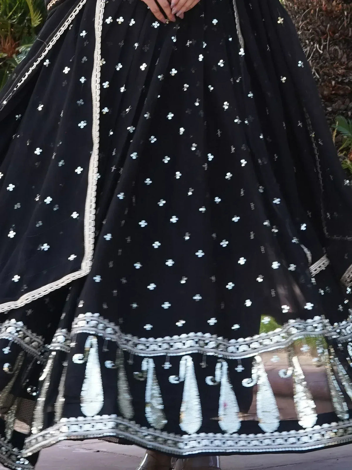 Black ethnic lehenga with white floral embroidery and mirror work, perfect for Indian weddings and festive occasions.