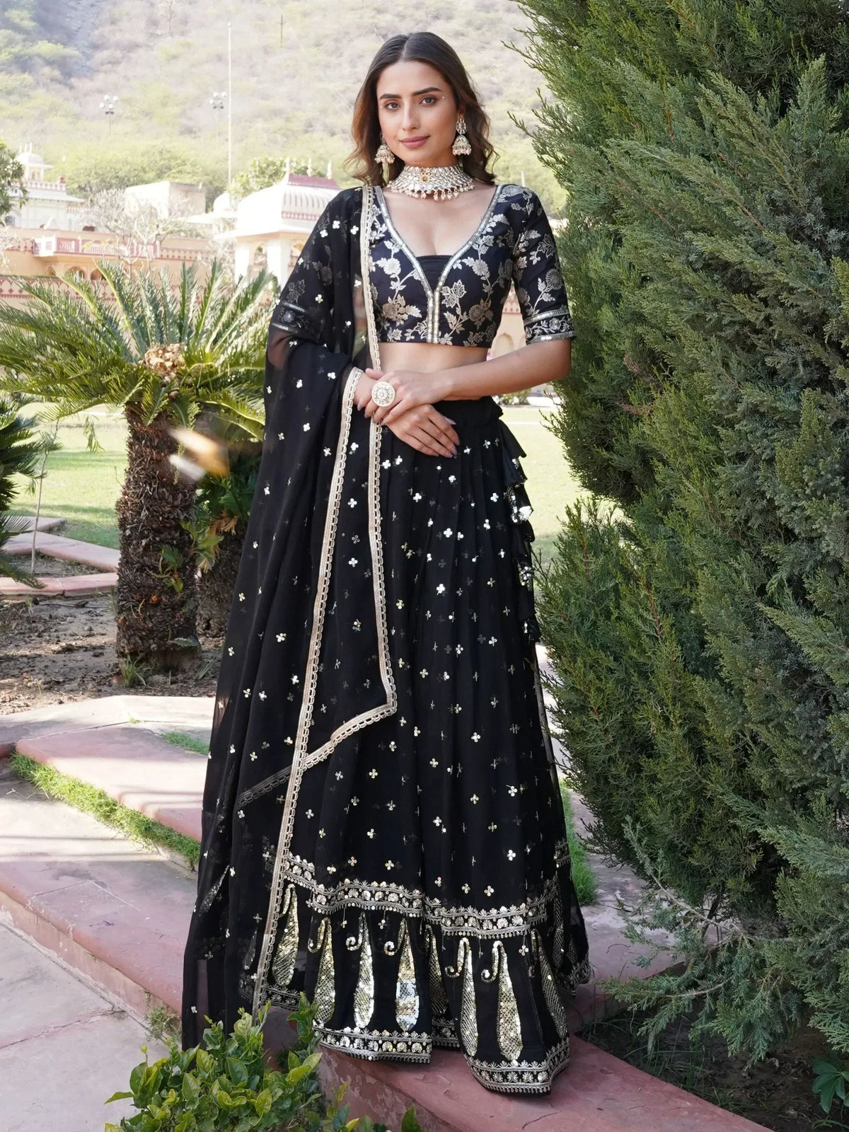 Black embroidered lehenga choli with gold detailing, perfect for Indian ethnic wear occasions.