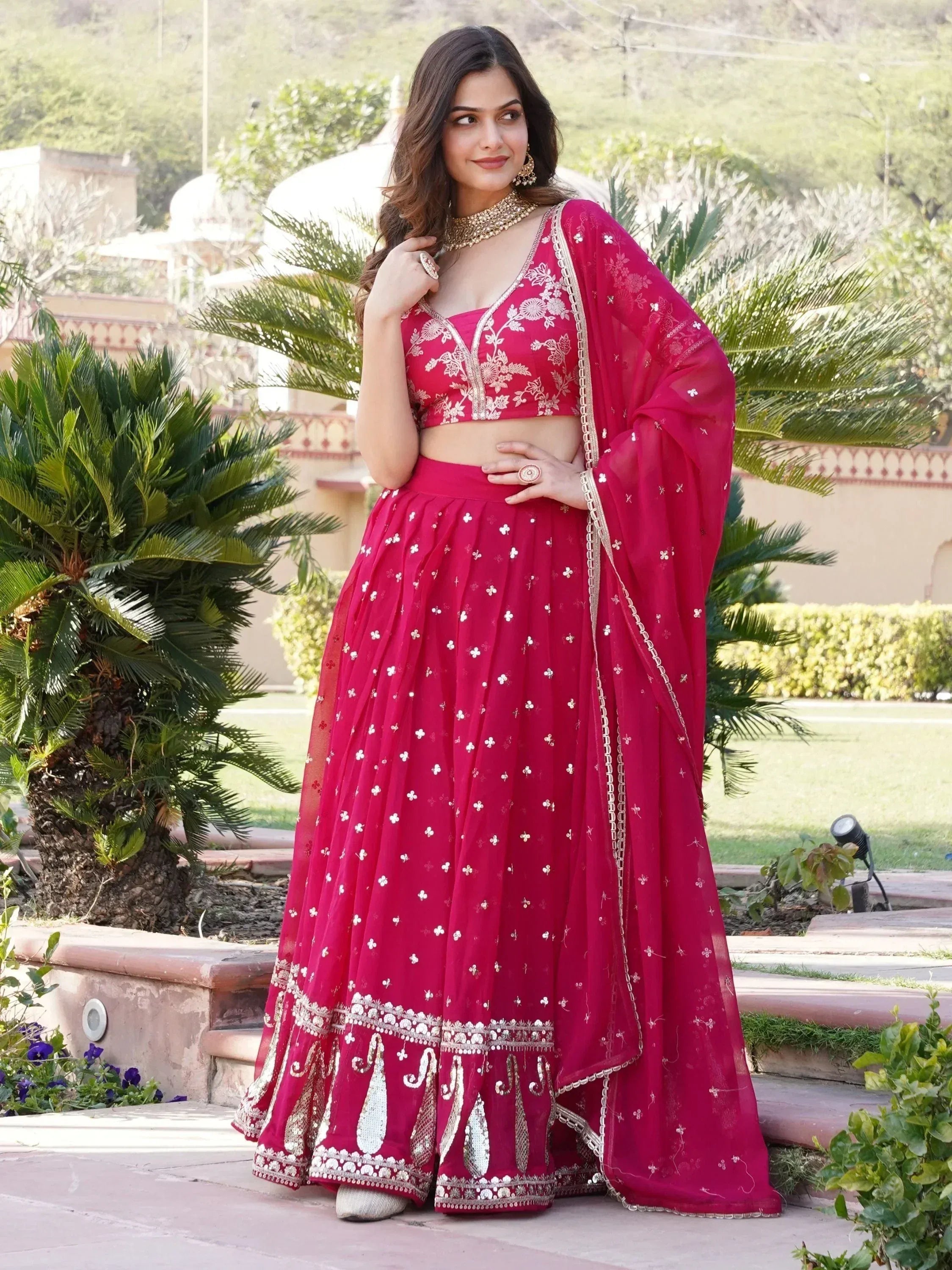 Red embroidered lehenga choli with floral motifs and gold detailing, perfect for Indian ethnic occasions