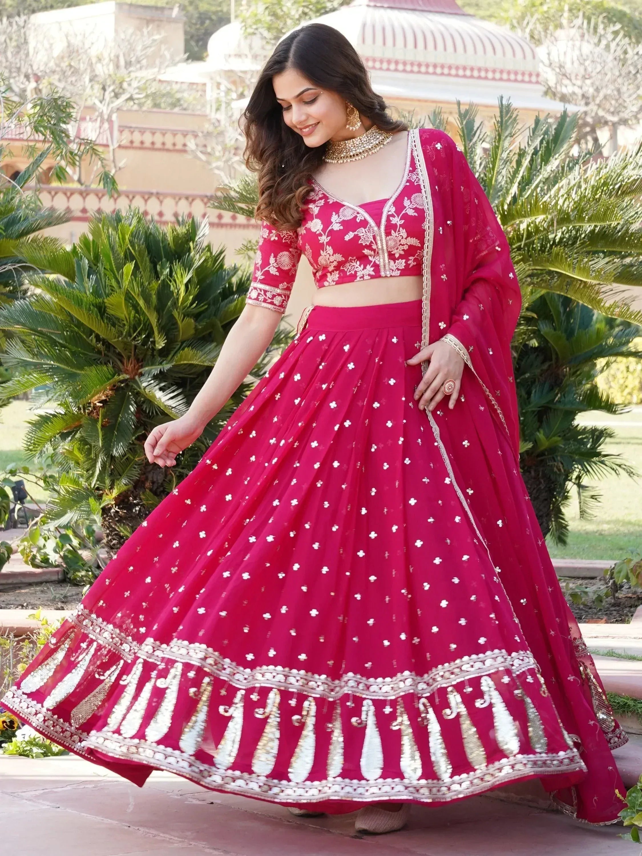 Elegant pink lehenga choli with floral embroidery and gold detailing, perfect for Indian weddings and festive occasions.