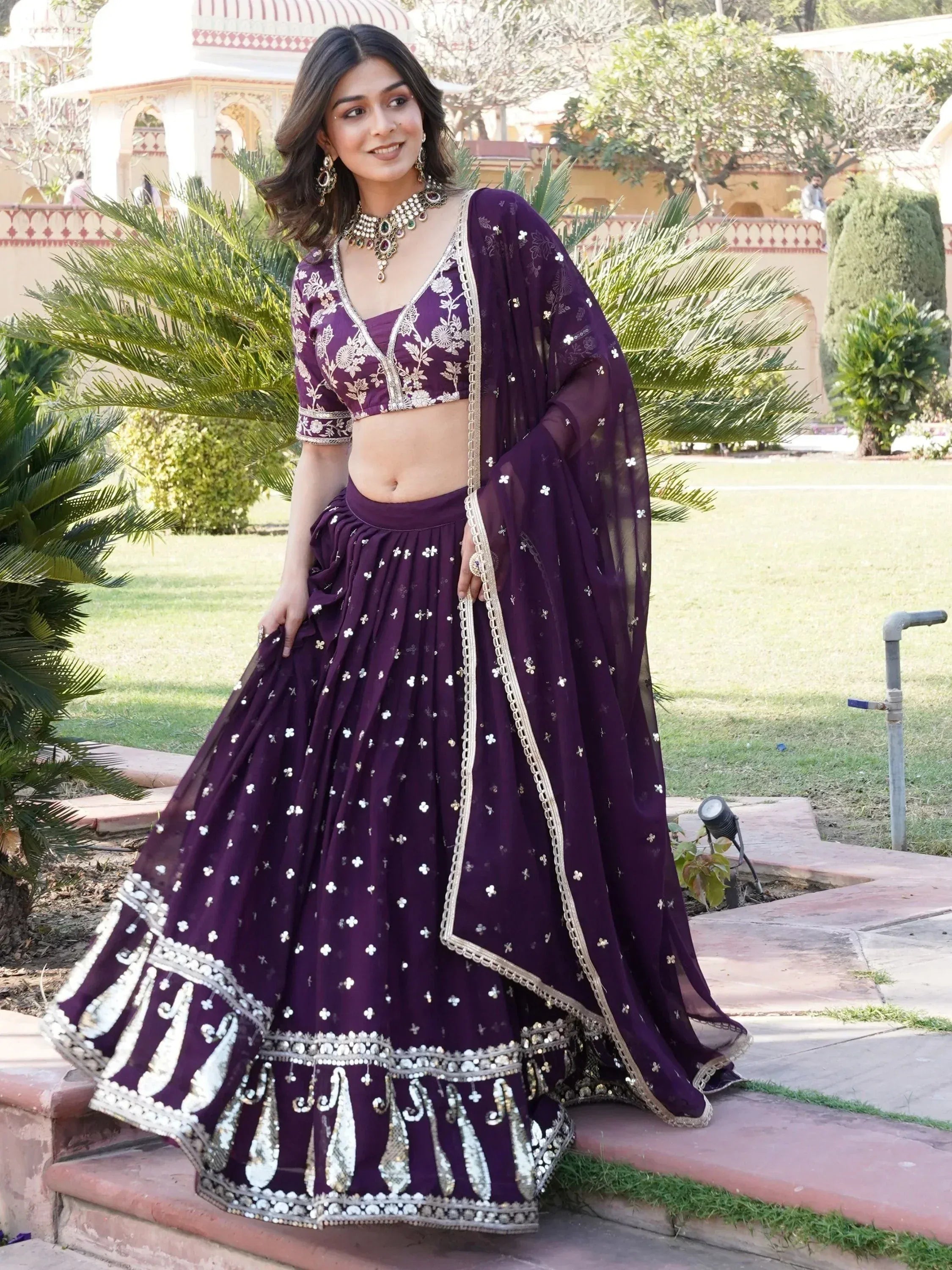 Purple embroidered lehenga choli with gold detailing, perfect for Indian weddings and festive occasions.