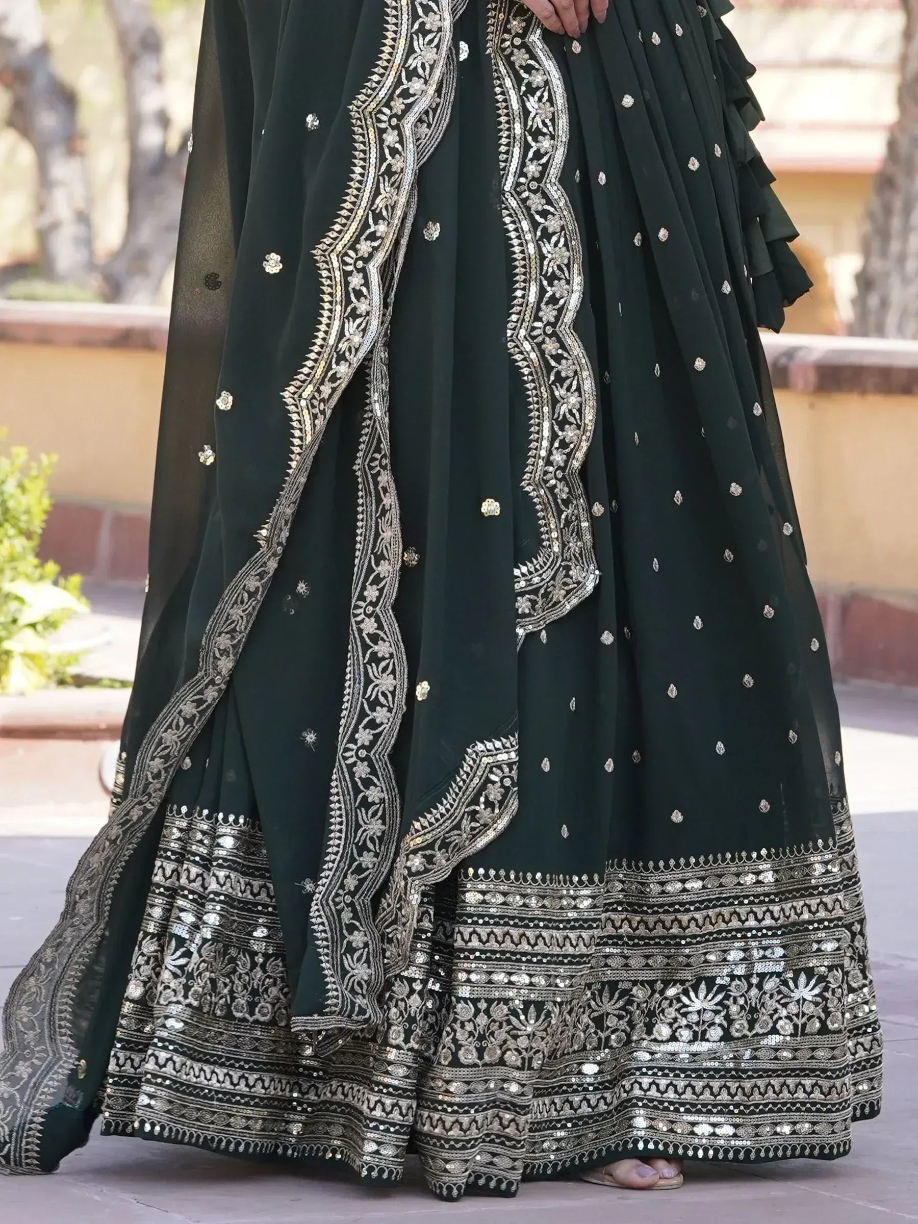 Dark green embroidered lehenga choli with silver zari work and ruffled dupatta, perfect for Indian ethnic occasions