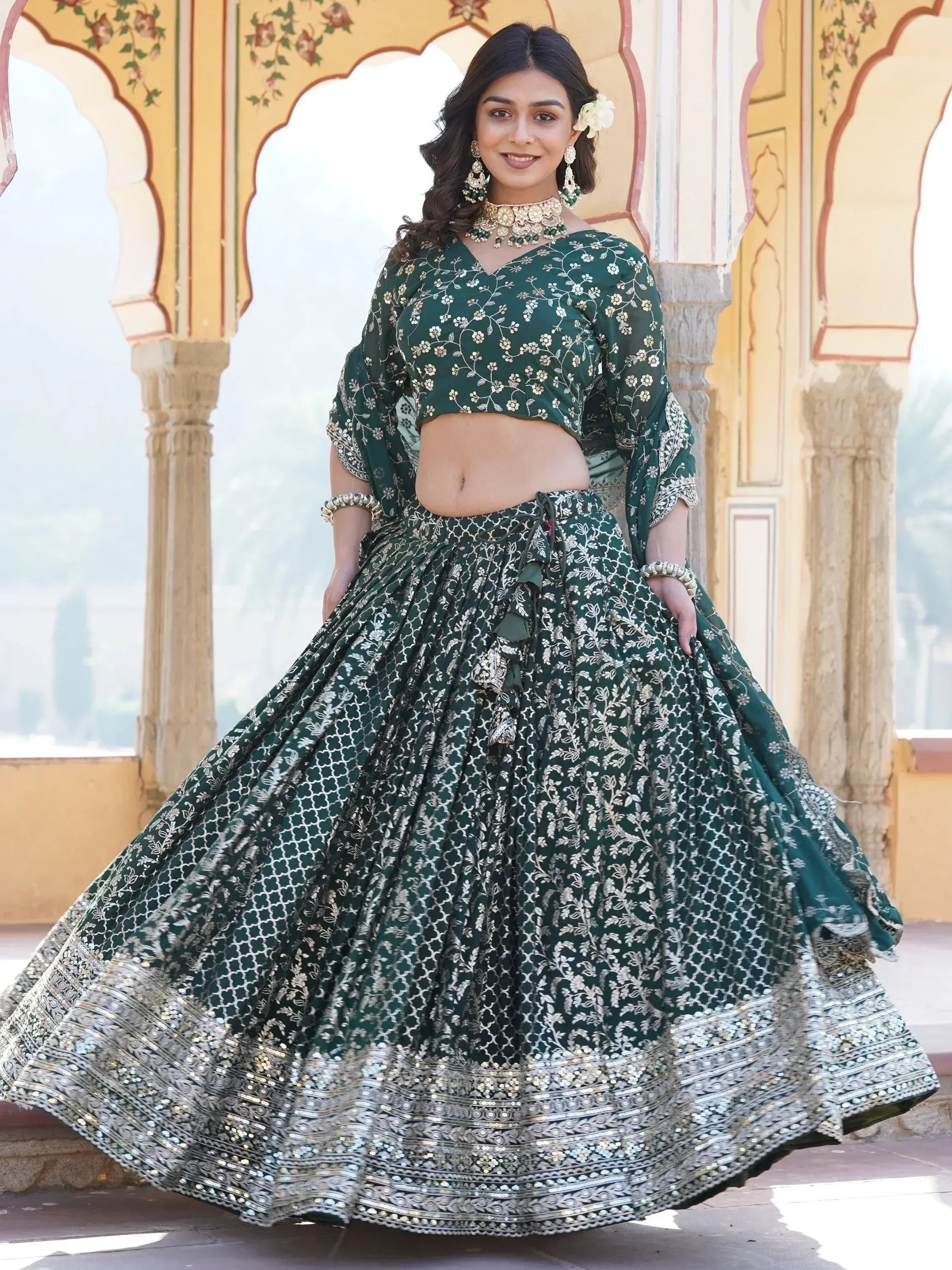 Elegant green embroidered lehenga choli with gold detailing, perfect for Indian weddings and festive occasions.