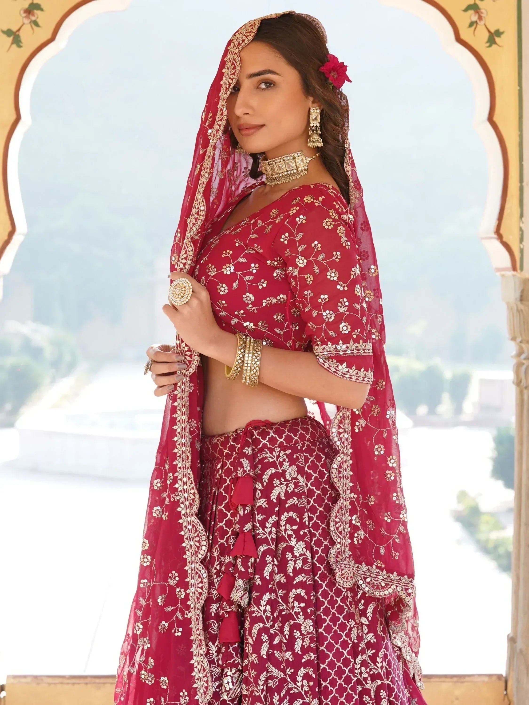 Red embroidered lehenga choli with gold detailing, perfect for Indian weddings and festive occasions.