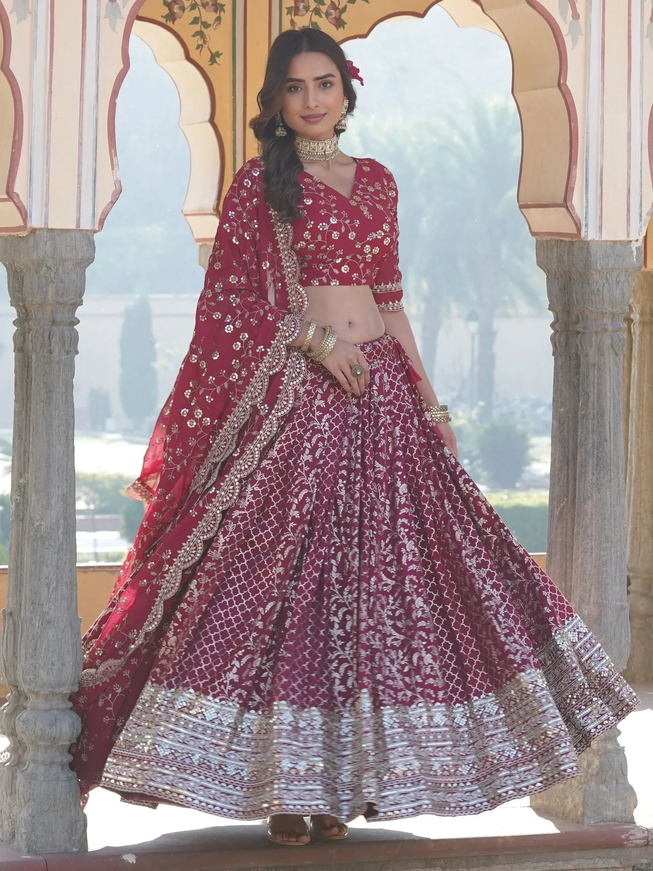 Maroon embroidered lehenga choli with gold detailing, perfect for Indian weddings and festive occasions