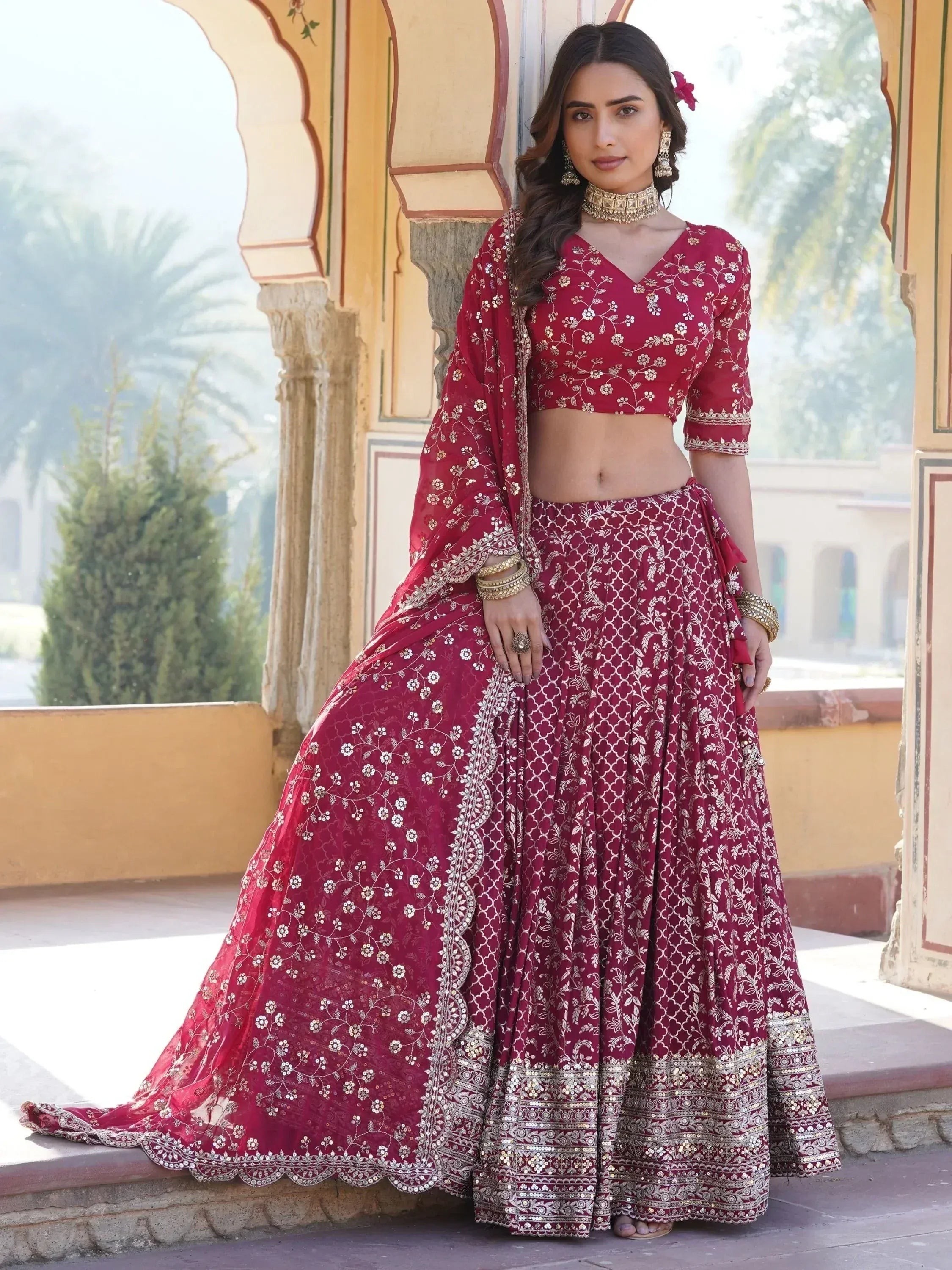 Maroon designer lehenga choli with gold floral embroidery, perfect for Indian weddings and festive occasions.