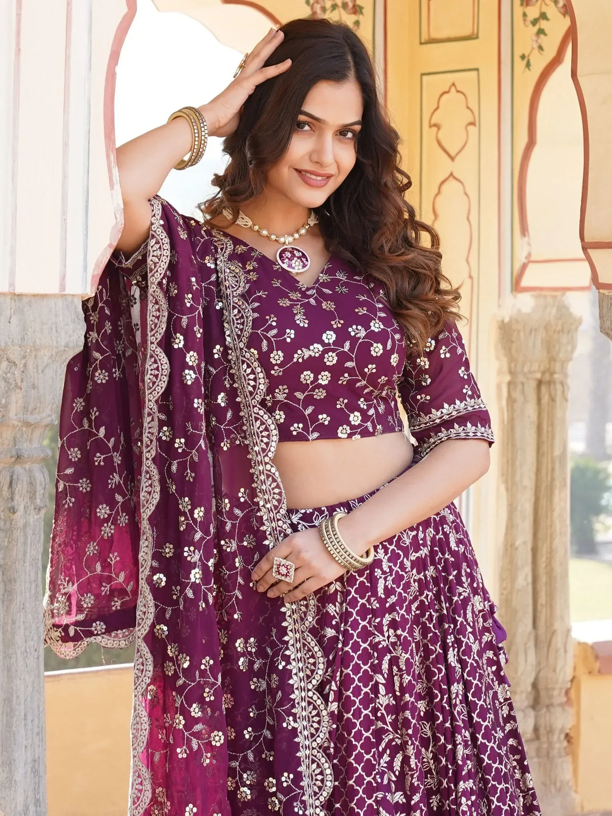 Elegant purple embroidered lehenga choli with floral motifs, perfect for Indian ethnic occasions