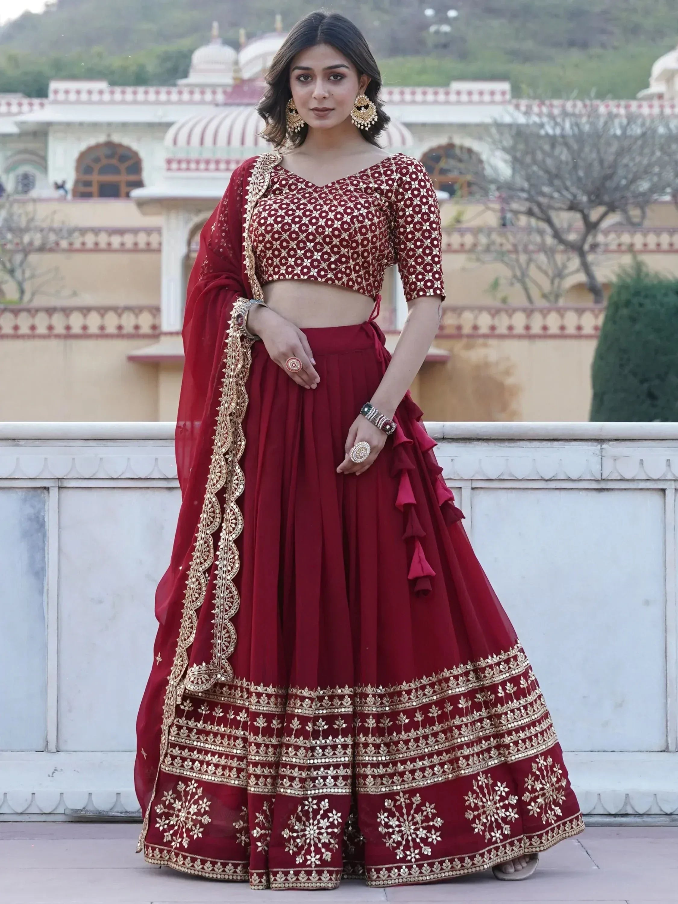 Maroon lehenga choli with gold embroidery, perfect for Indian weddings and festive occasions