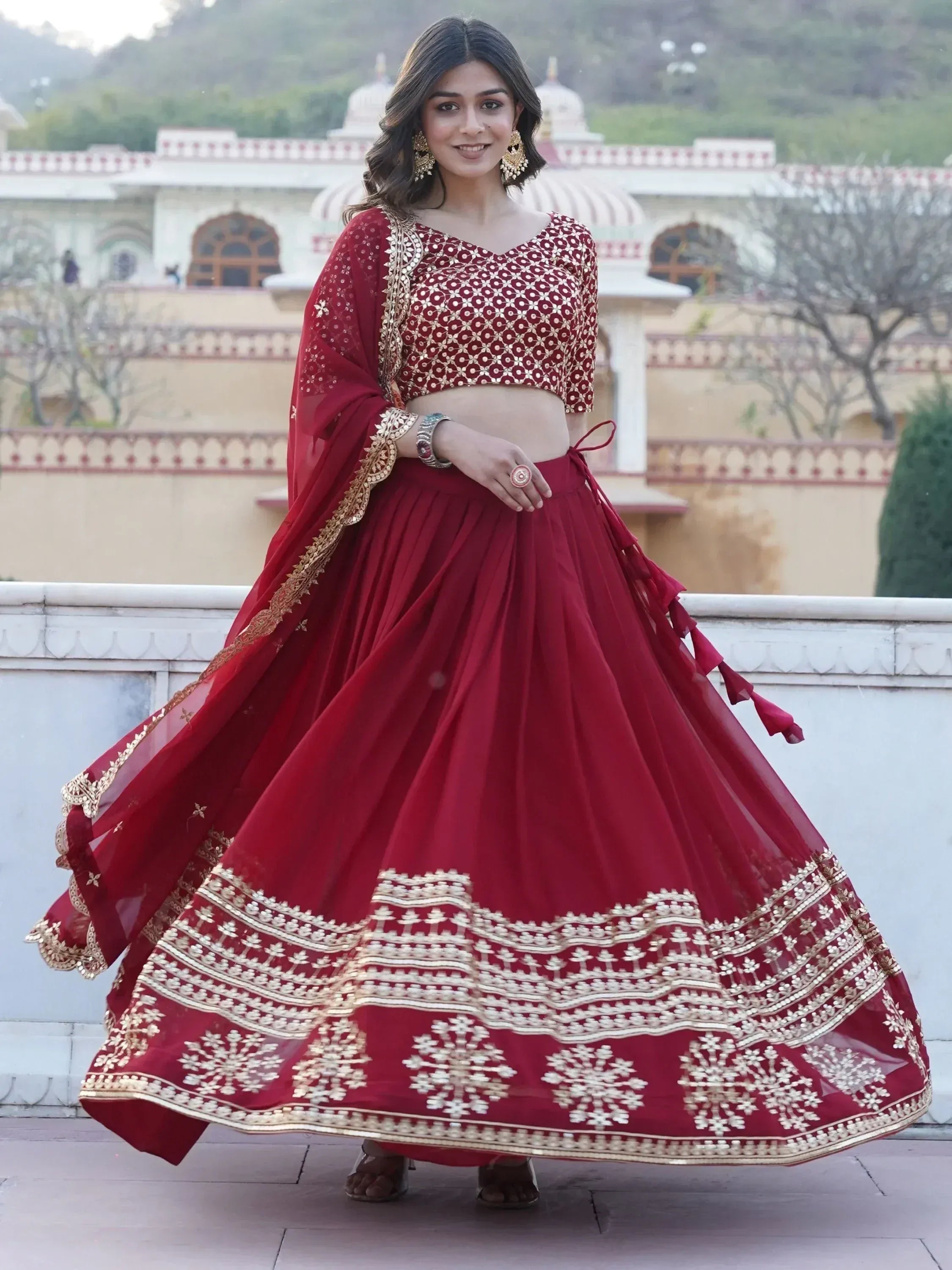 Red designer lehenga choli with gold embroidery, perfect for Indian weddings and festive occasions