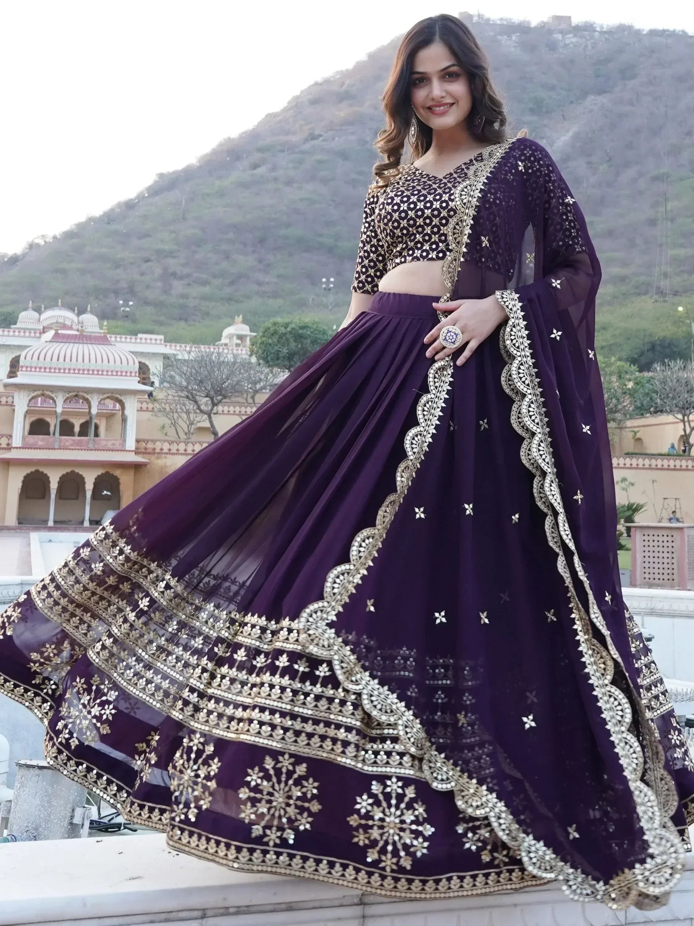 Purple designer lehenga choli with gold embroidery, perfect for Indian weddings and festive occasions.