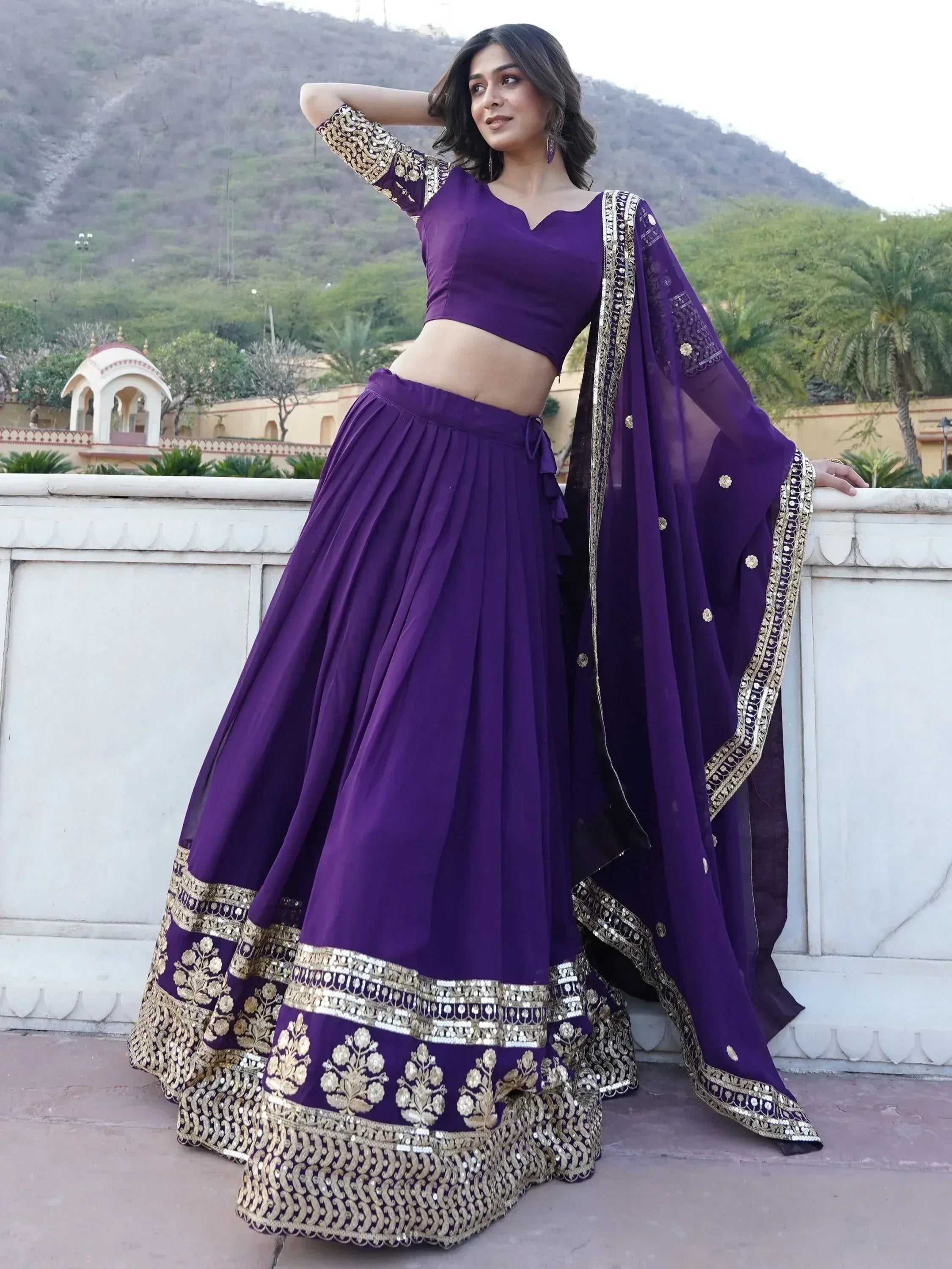 Purple designer lehenga choli with gold embroidery, perfect for Indian ethnic wear and festive occasions.