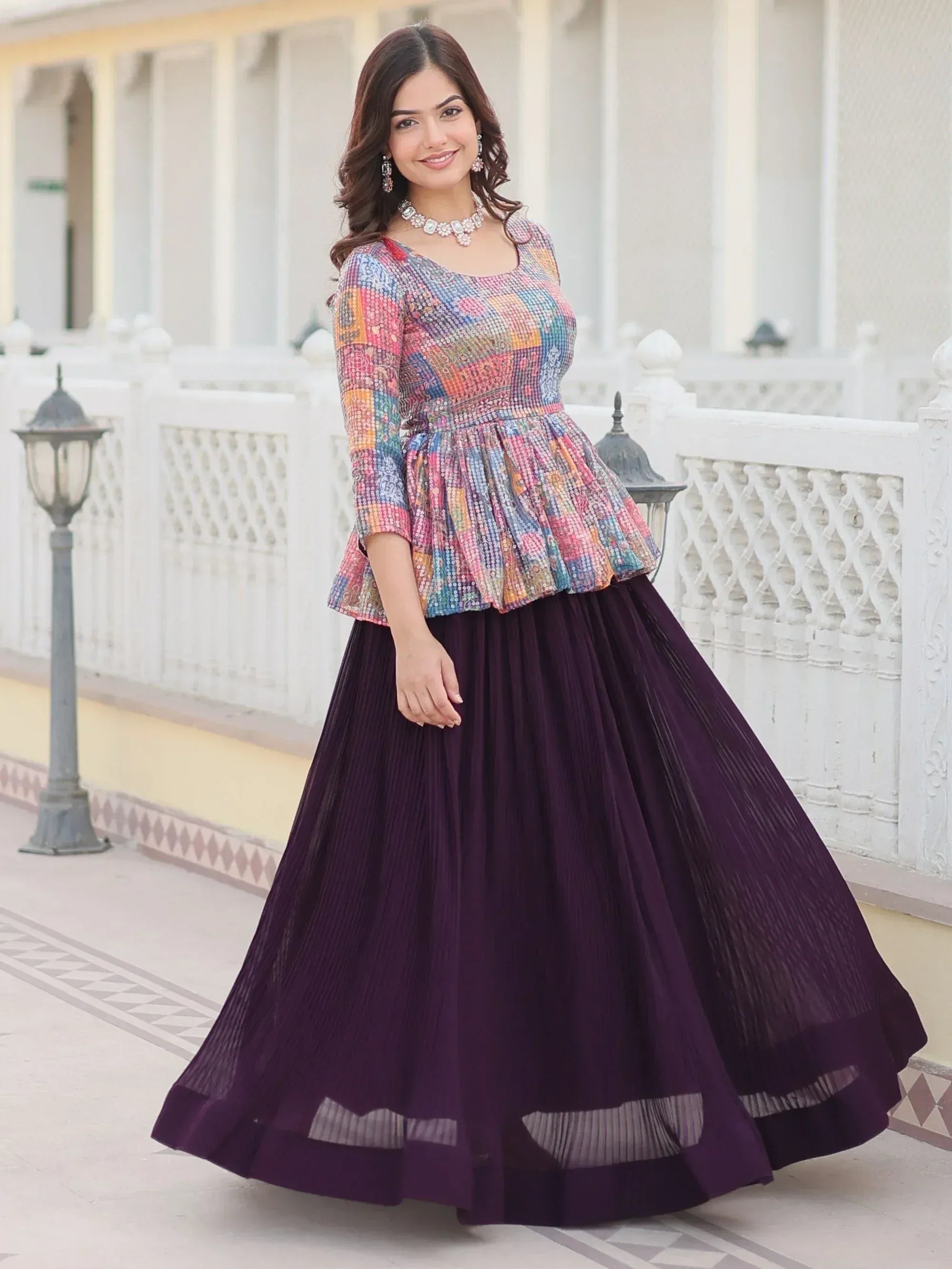 Woman in colorful embroidered top with purple pleated skirt, Indian ethnic wear