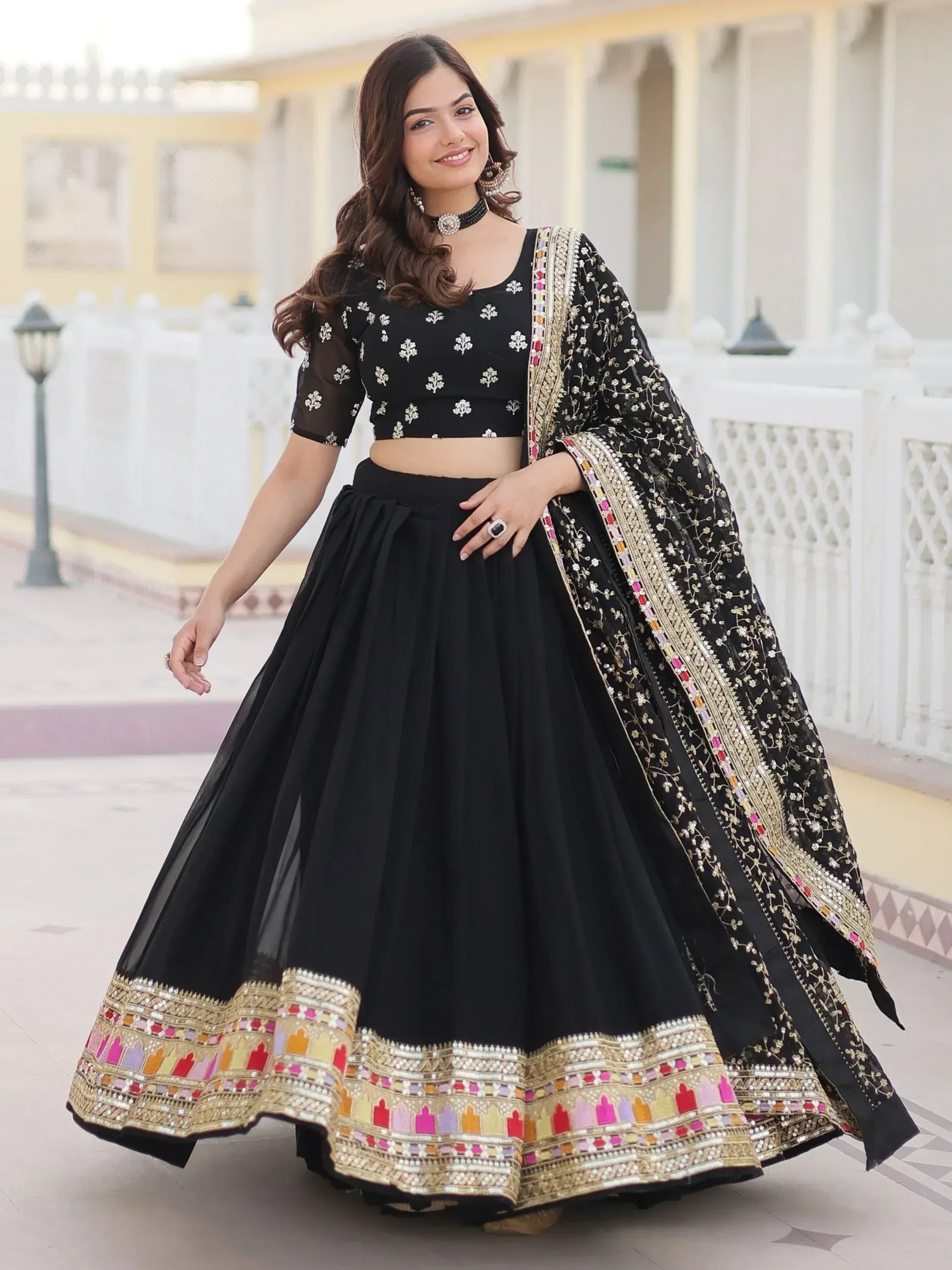 Black embroidered lehenga choli with colorful border, perfect for Indian ethnic wear and festive occasions.