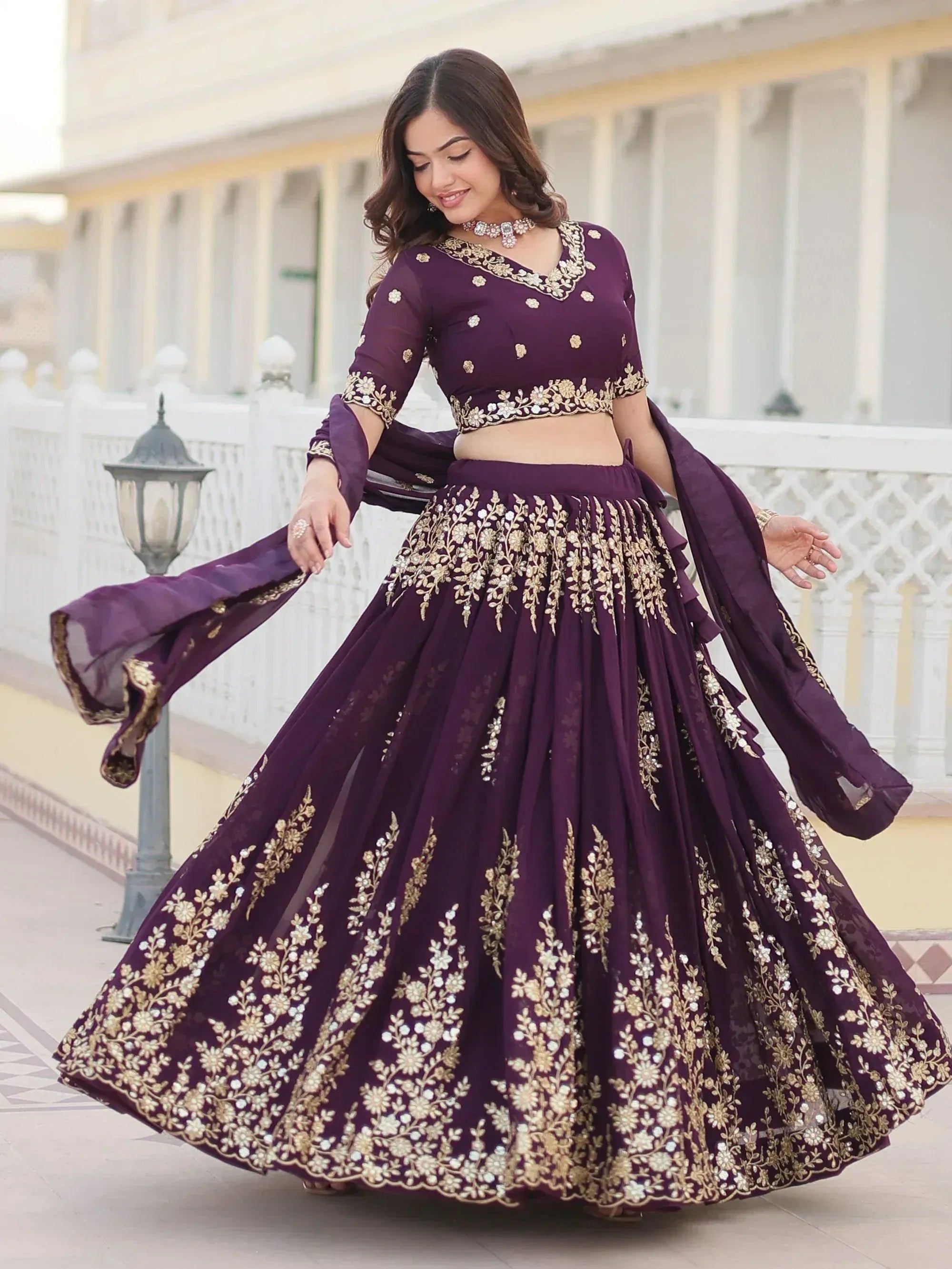 Elegant purple lehenga choli with gold floral embroidery, perfect for Indian weddings and festive occasions.