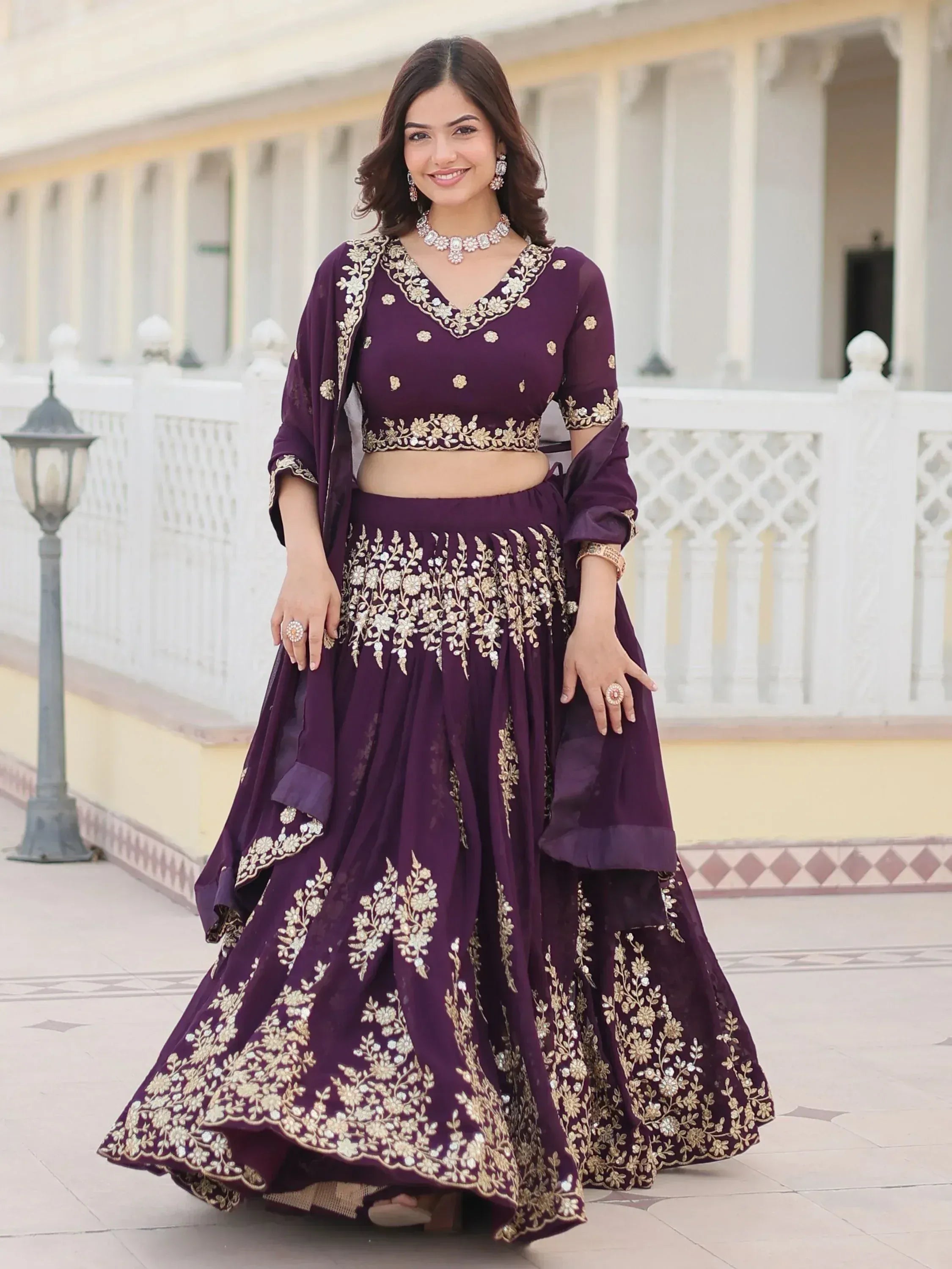 Purple embroidered lehenga choli with gold floral work, perfect for Indian ethnic wear events