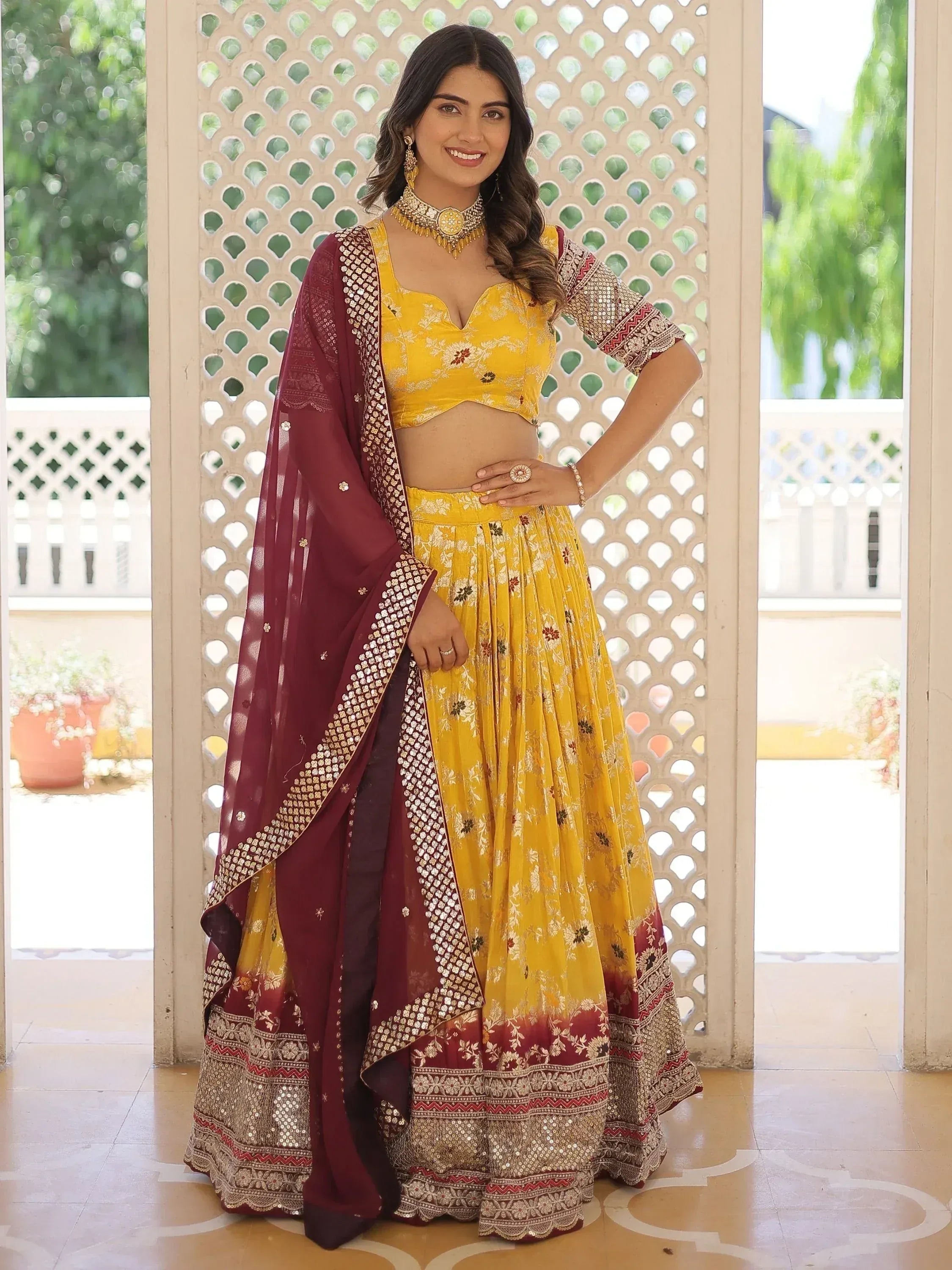 Yellow floral lehenga choli with maroon dupatta, perfect for Indian ethnic wear