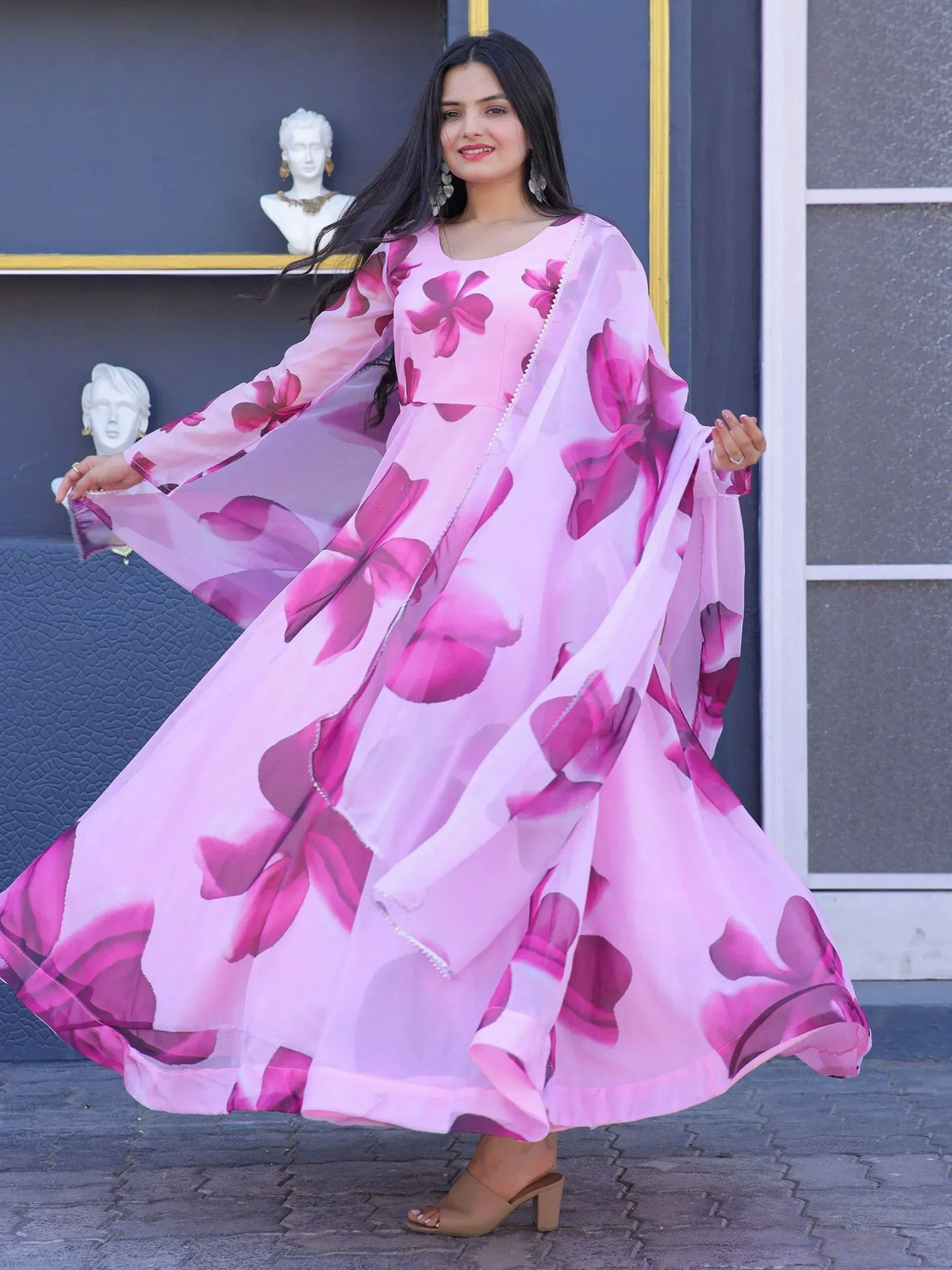 Pink floral print ethnic gown with flowing sleeves, perfect for Indian occasions and festive wear.