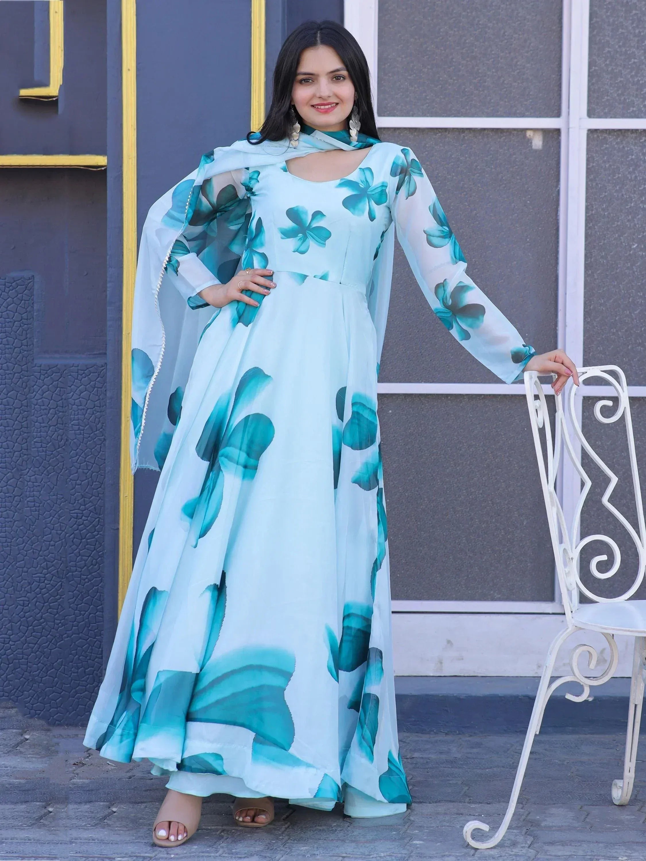 Woman in light blue floral print ethnic gown with matching dupatta, stylish Indian wear