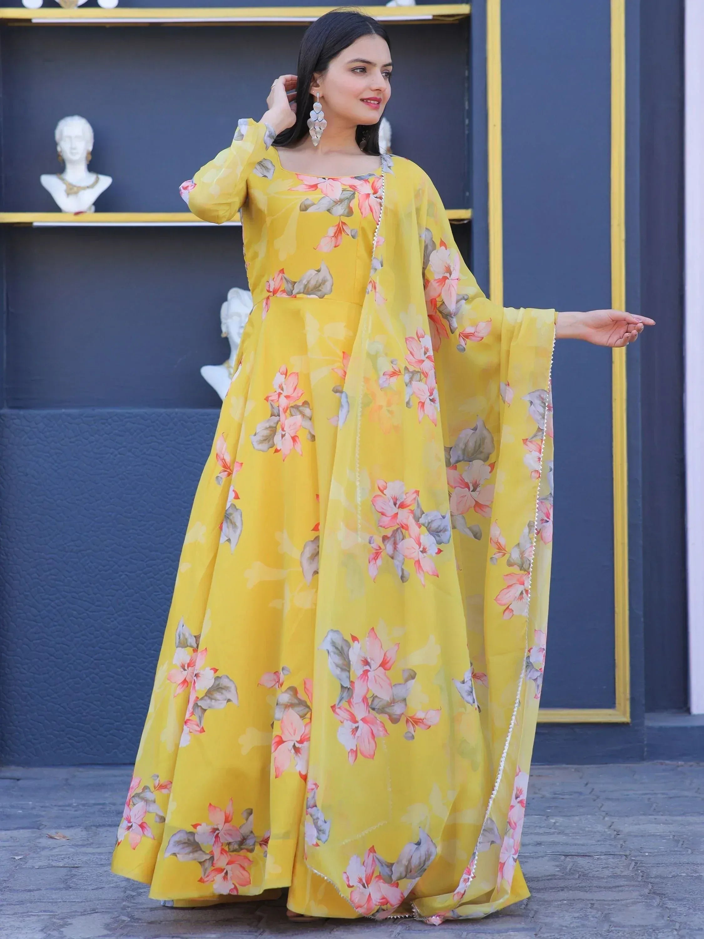 Yellow floral print ethnic gown with cape sleeves, perfect for Indian festive occasions