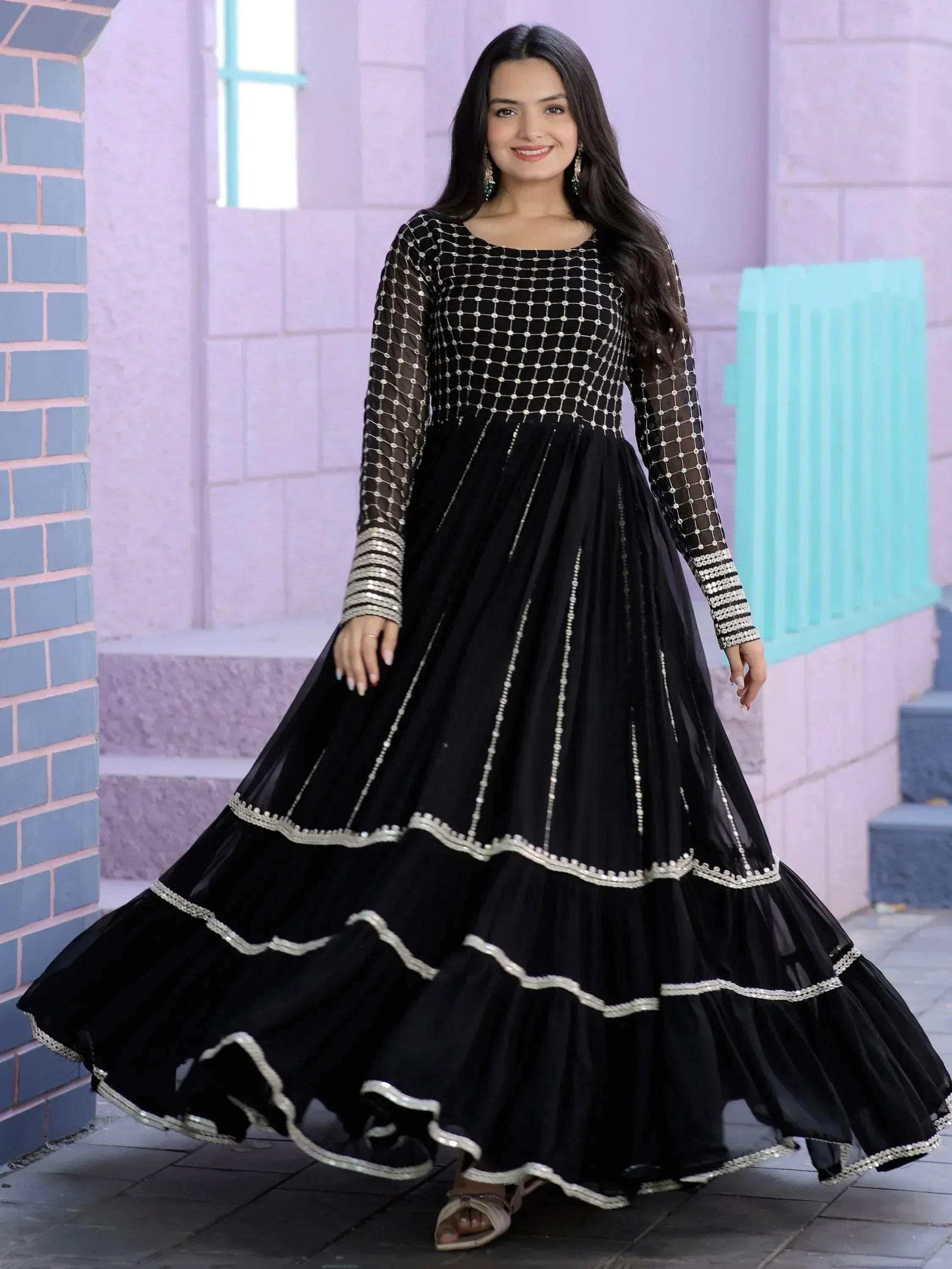 Black ethnic gown with silver embroidery, sheer sleeves, and tiered skirt for Indian wear
