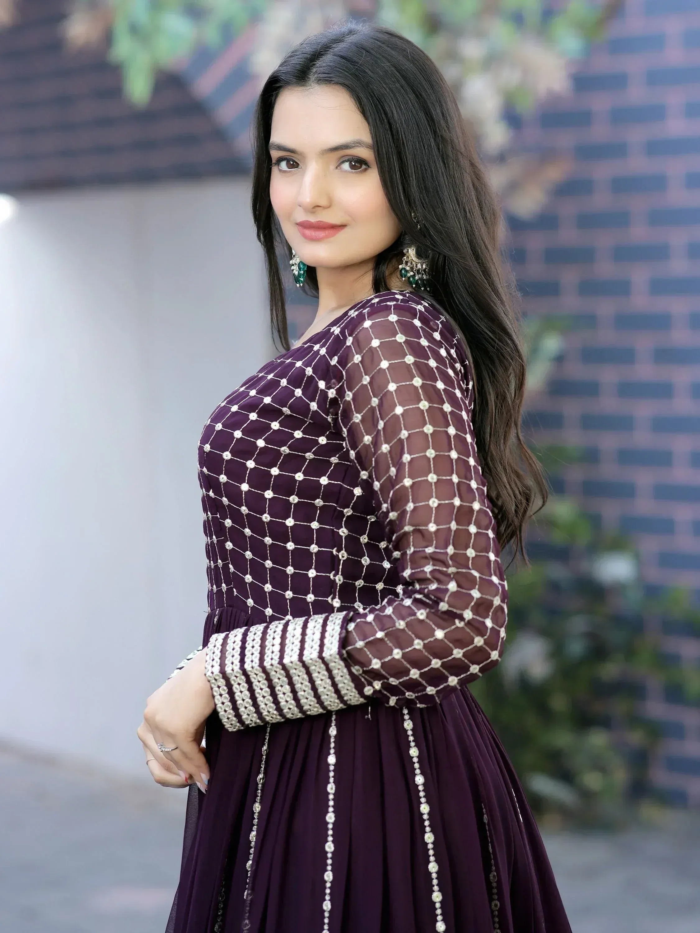 Woman in purple ethnic gown with silver embroidery, perfect for Indian occasions and festive wear.
