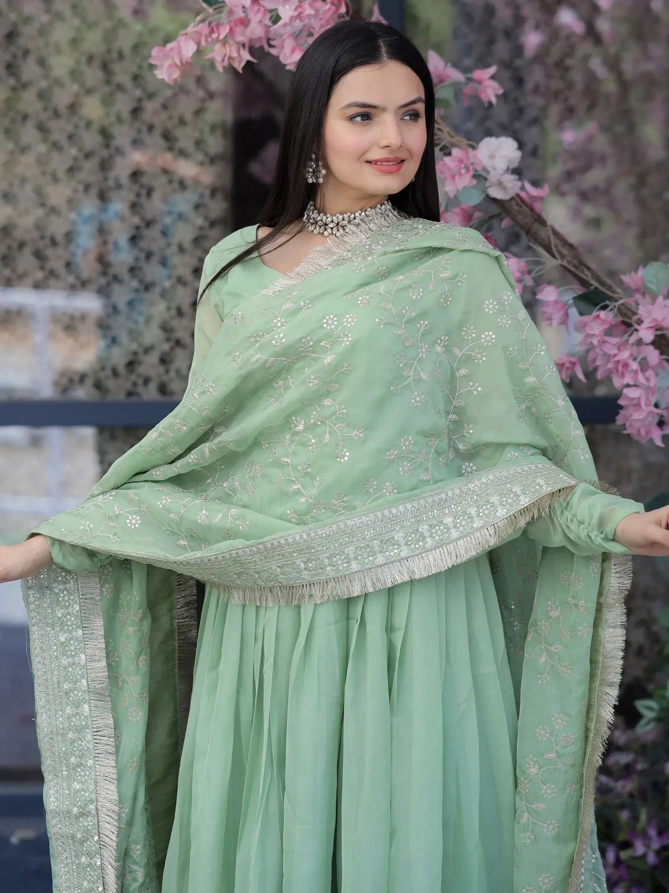 Mint green embroidered salwar kameez with floral detailing and silver embellishments, perfect for ethnic occasions.