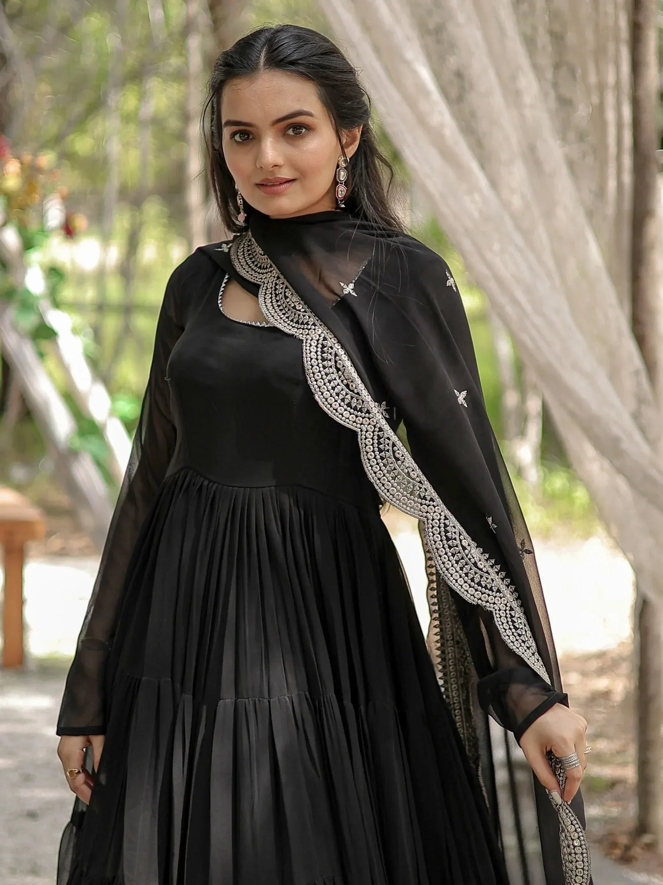 Black ethnic gown with silver embroidery and sheer dupatta, perfect for Indian festive occasions.