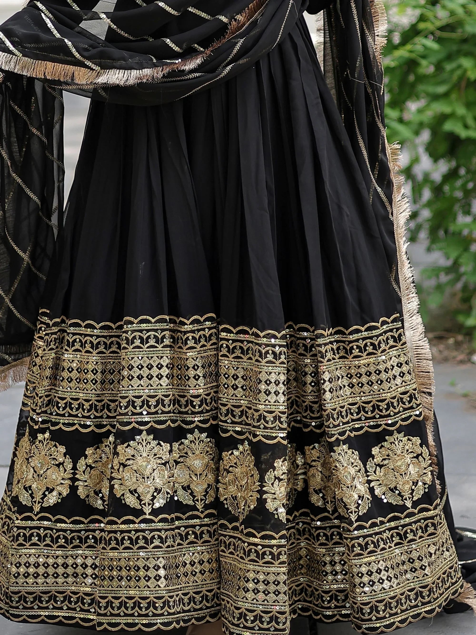 Black lehenga with gold embroidery and sequins, featuring a matching dupatta