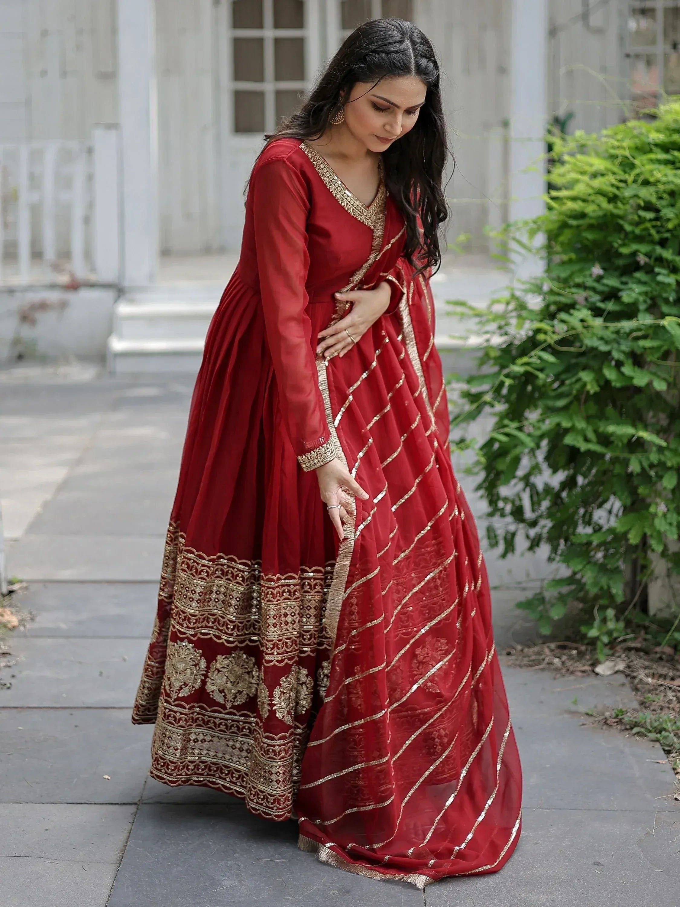 Red ethnic gown with gold embroidery, perfect for Indian weddings and festive occasions