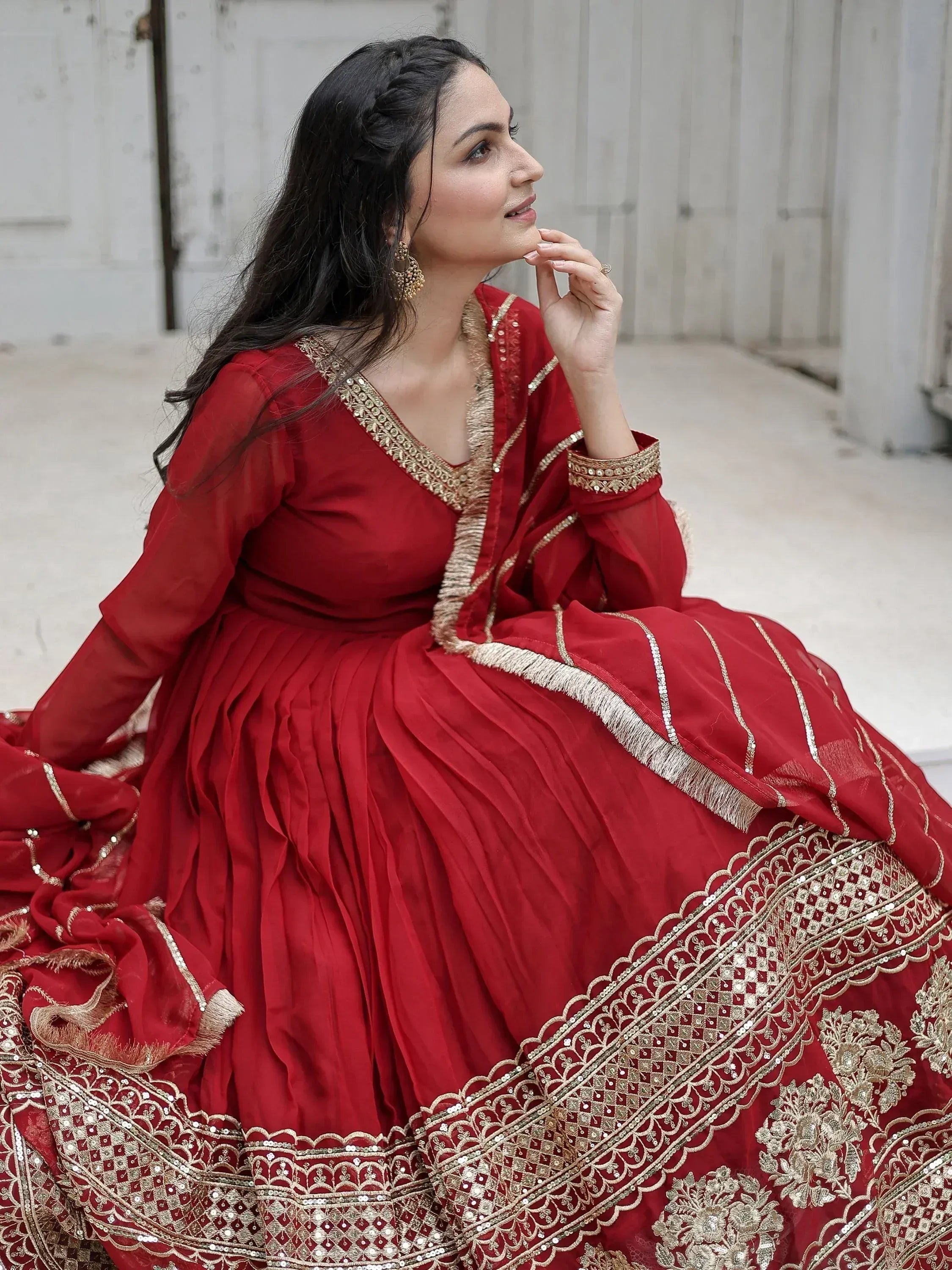 Red ethnic gown with gold embroidery, perfect for Indian weddings and festive occasions.