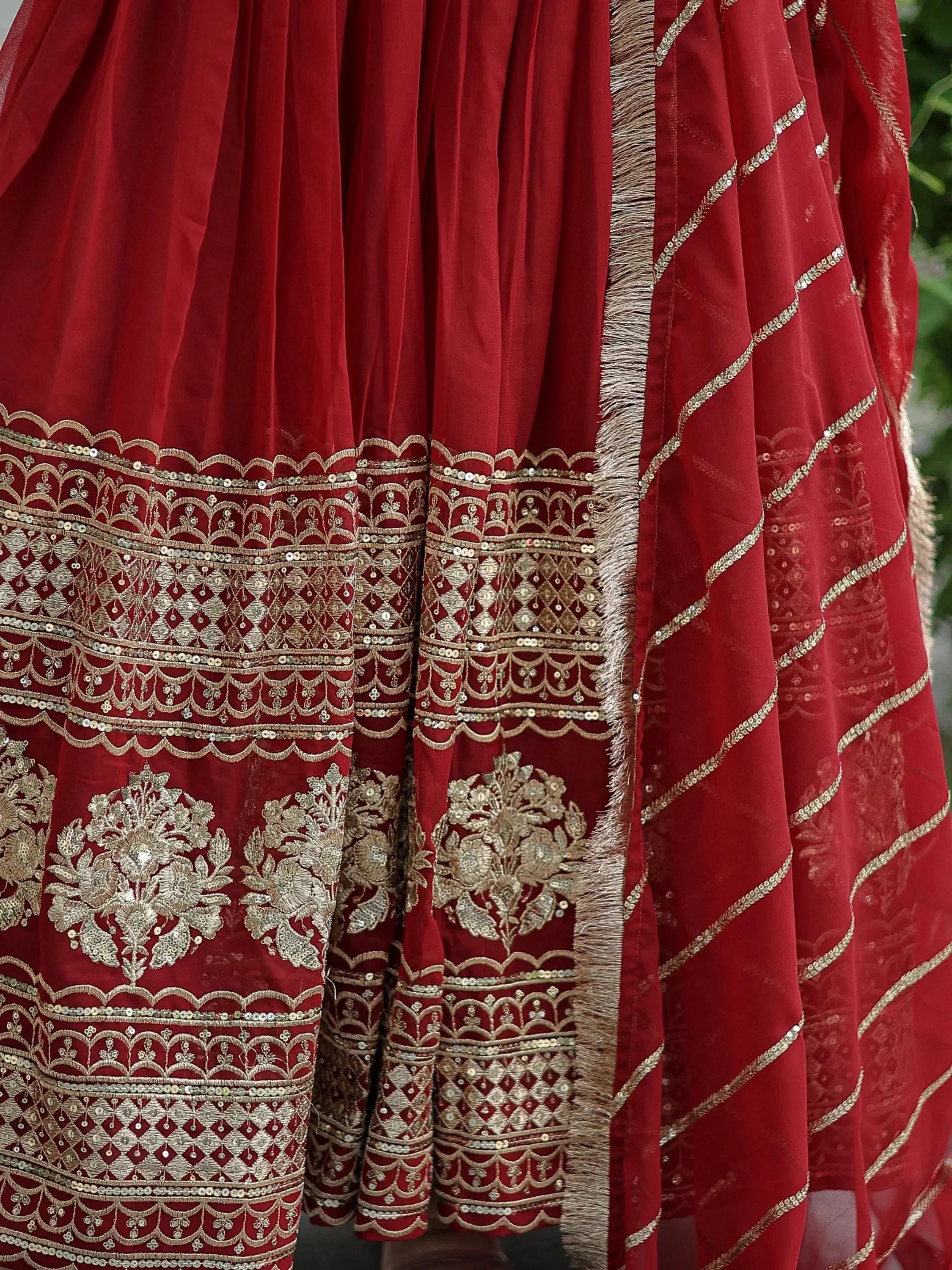 Red velvet lehenga with gold embroidery and sequin work, perfect for Indian ethnic wear