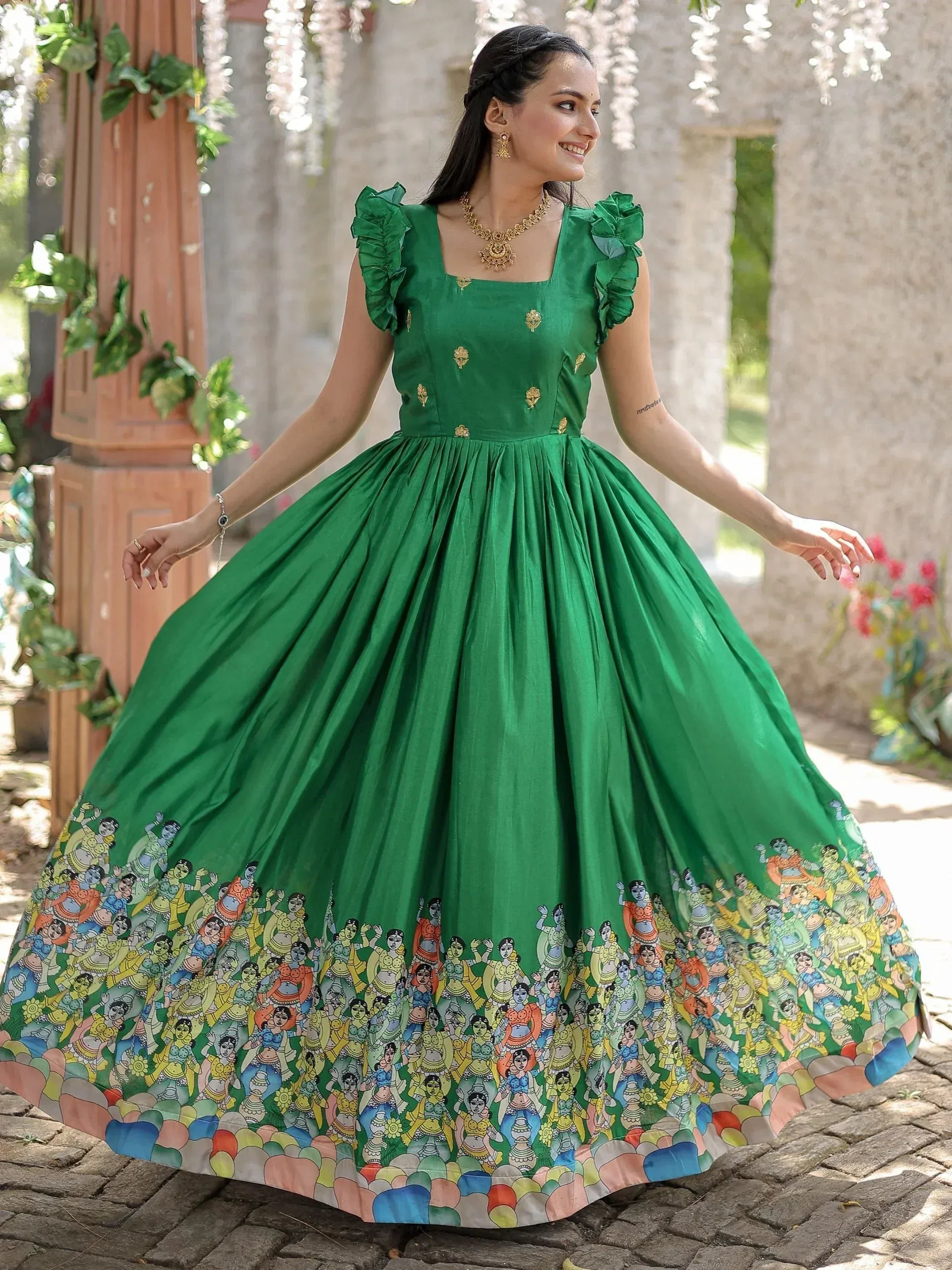 Green ethnic gown with ruffled sleeves and colorful printed border, perfect for festive occasions
