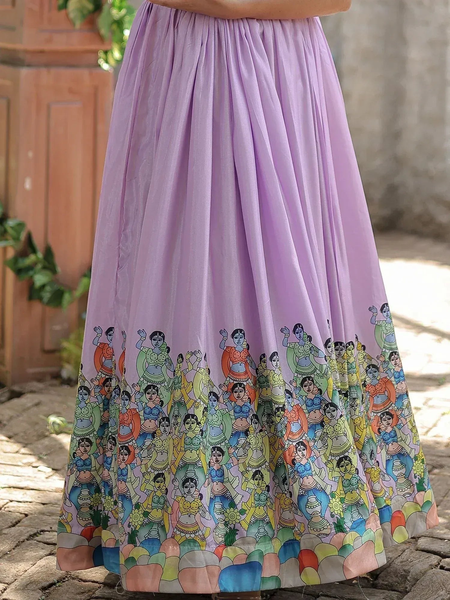 Lavender ethnic skirt with colorful folk dancer print, ideal for Indian wear and festive occasions.