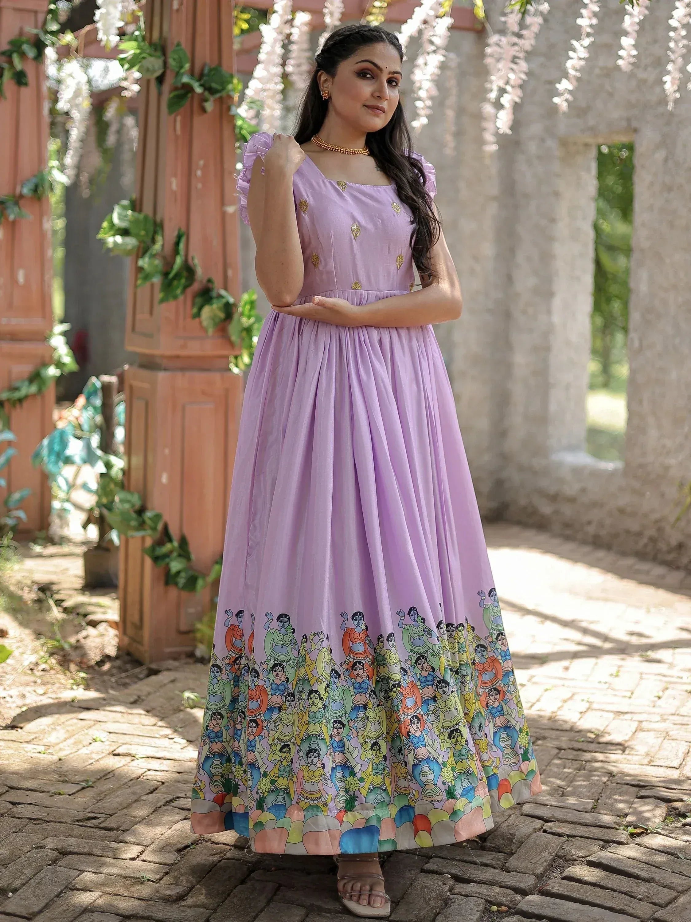 Lavender ethnic gown with colorful folk art print, perfect for Indian celebrations and festive occasions.