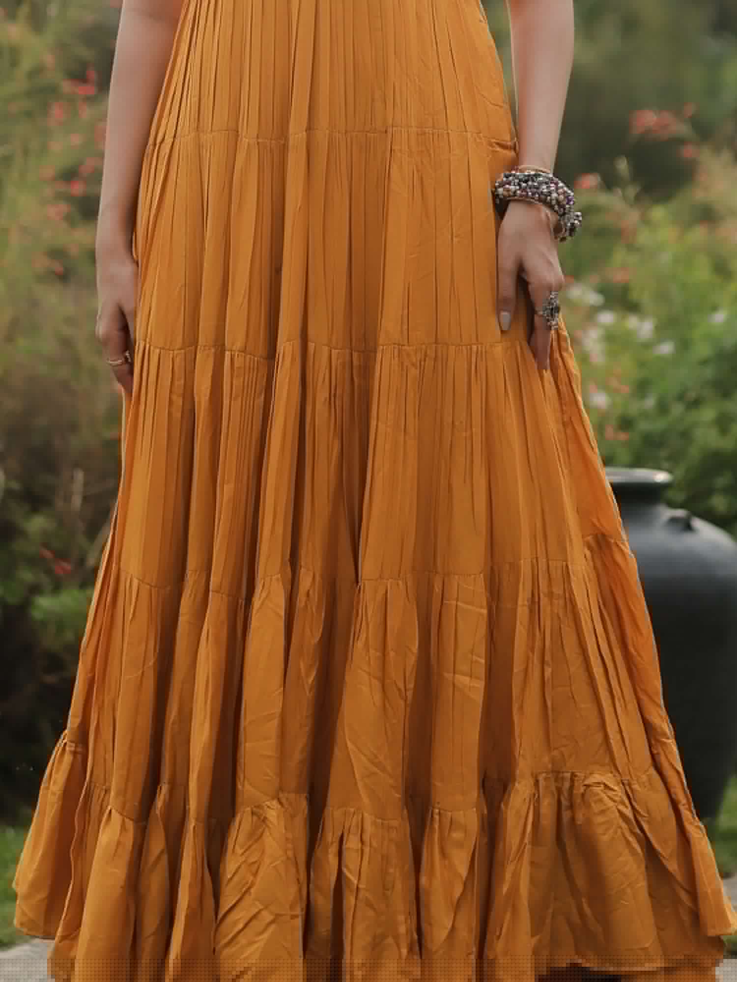 Mustard yellow ethnic long dress with pleated detail, outdoor garden setting