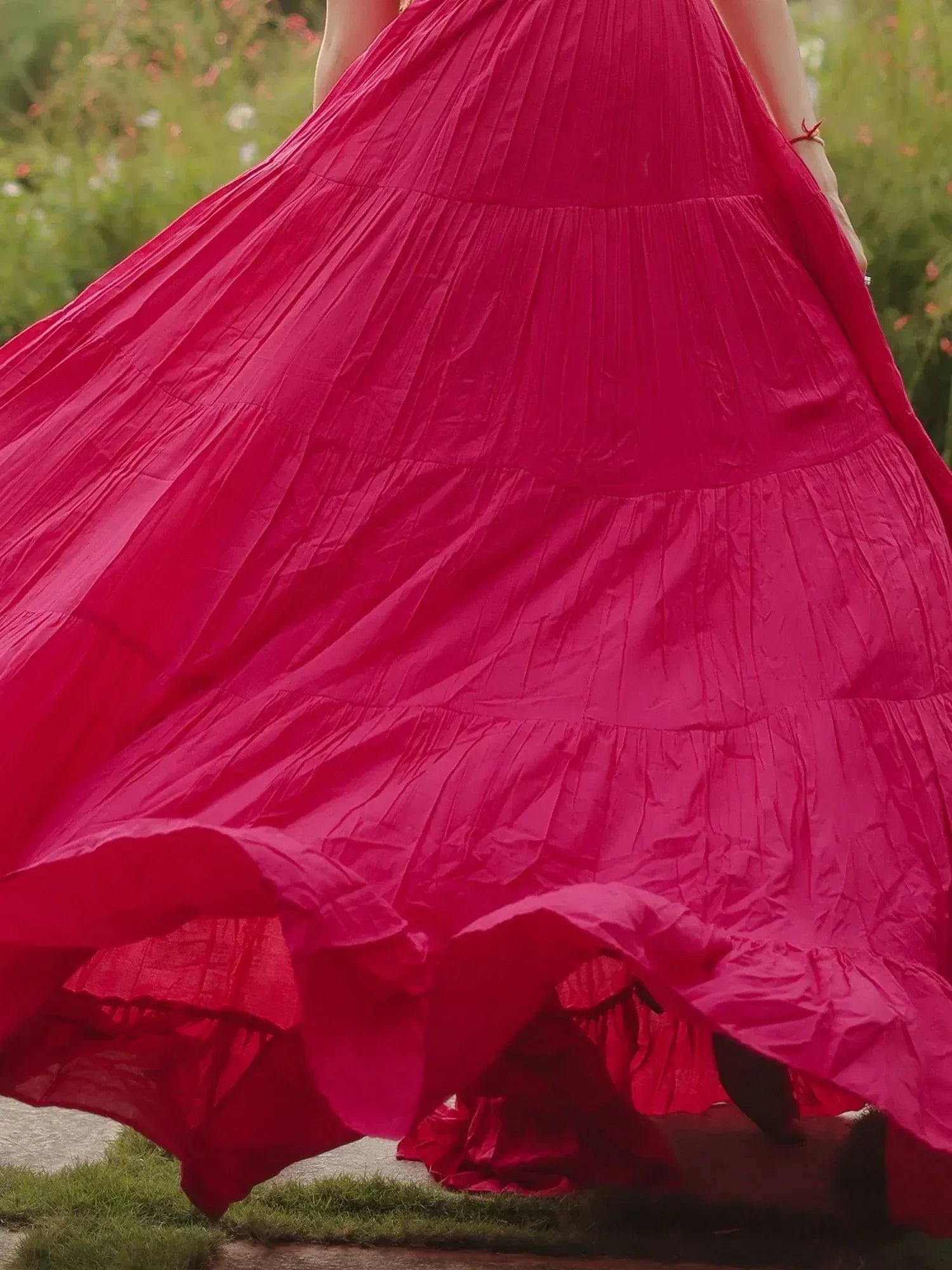 Vibrant pink ethnic gown with flowing pleated skirt, perfect for festive occasions