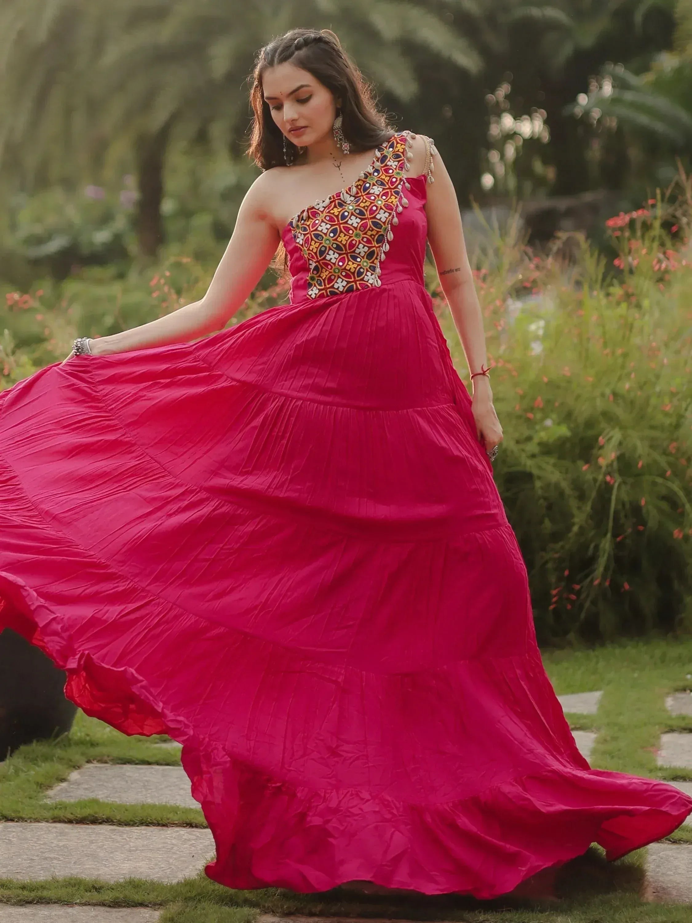 Vibrant pink ethnic gown with colorful mirror work, perfect for Indian festive occasions and weddings.