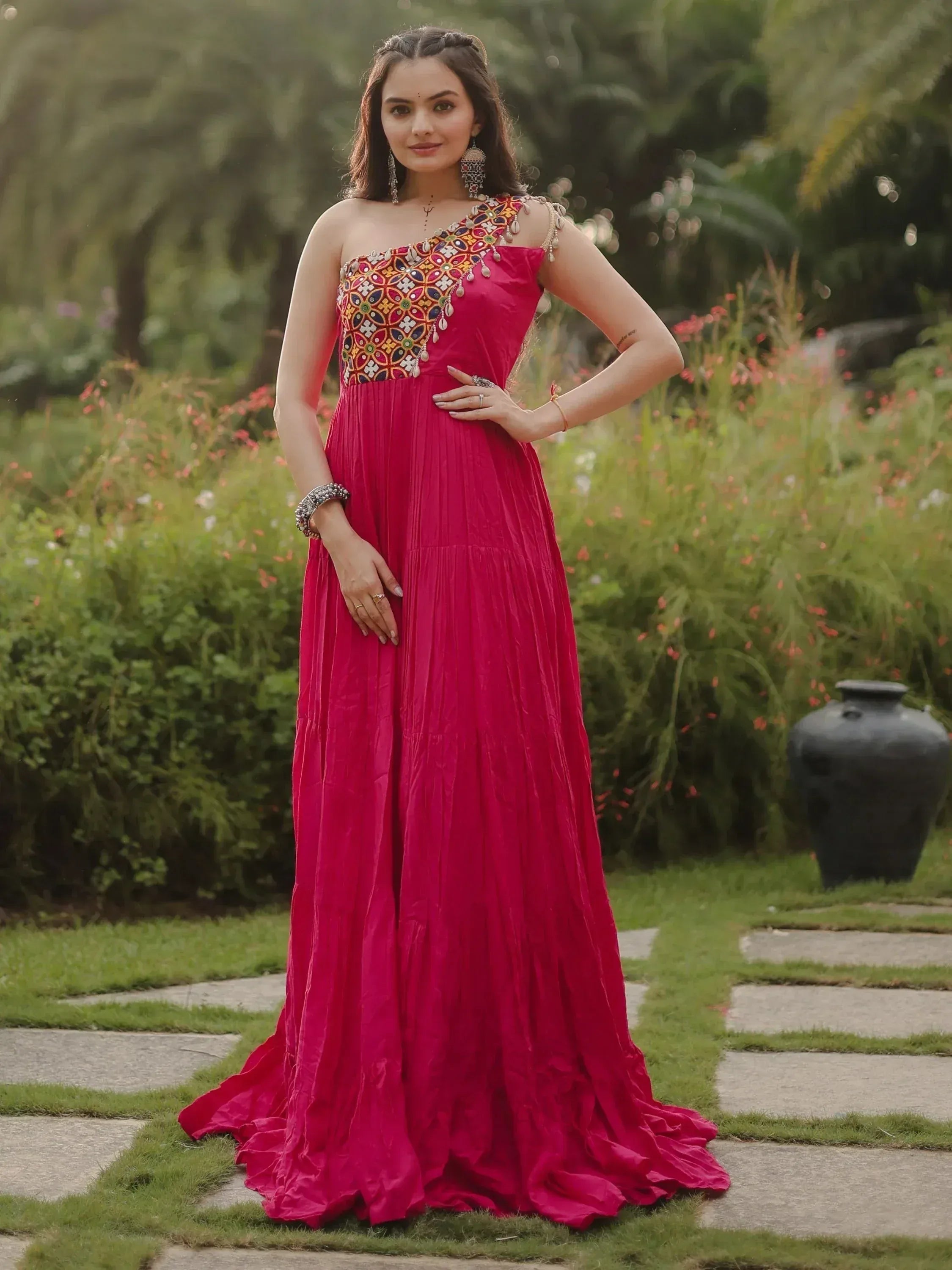 Fuchsia ethnic gown with one-shoulder embroidered bodice, perfect for Indian weddings or festive occasions.
