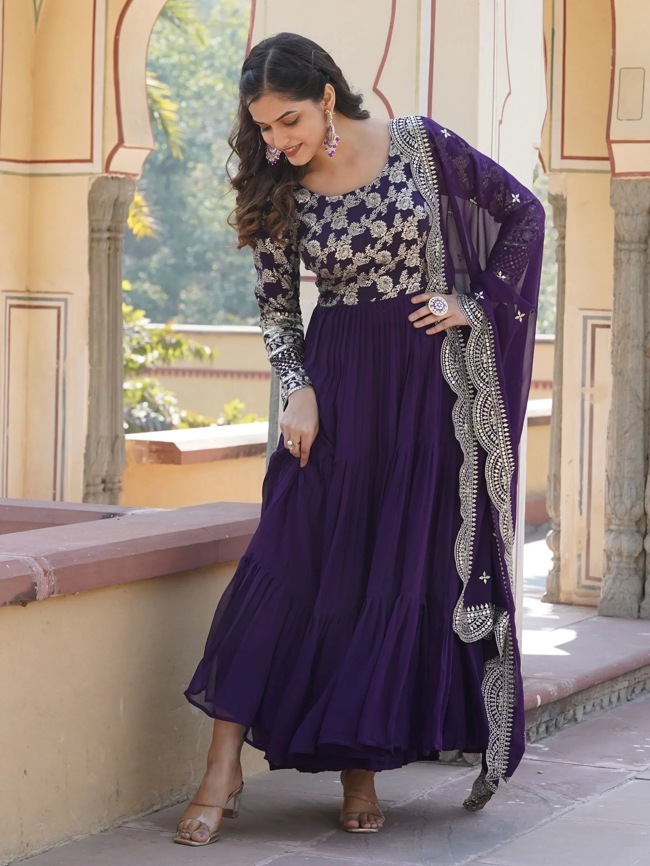 Woman in purple embroidered ethnic gown with silver detailing and matching dupatta