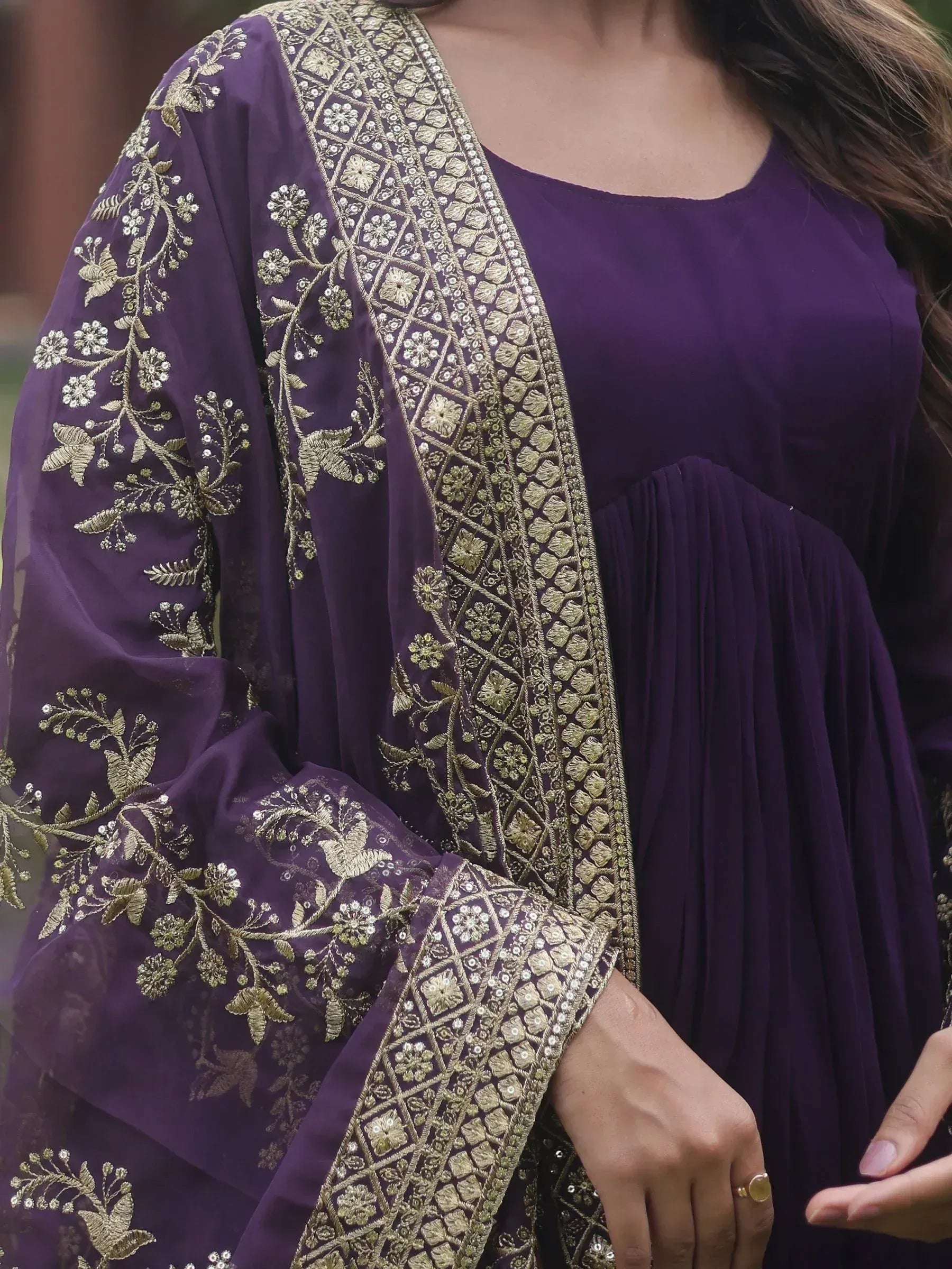 Purple ethnic gown with gold floral embroidery and detailed neckline, perfect for Indian occasions