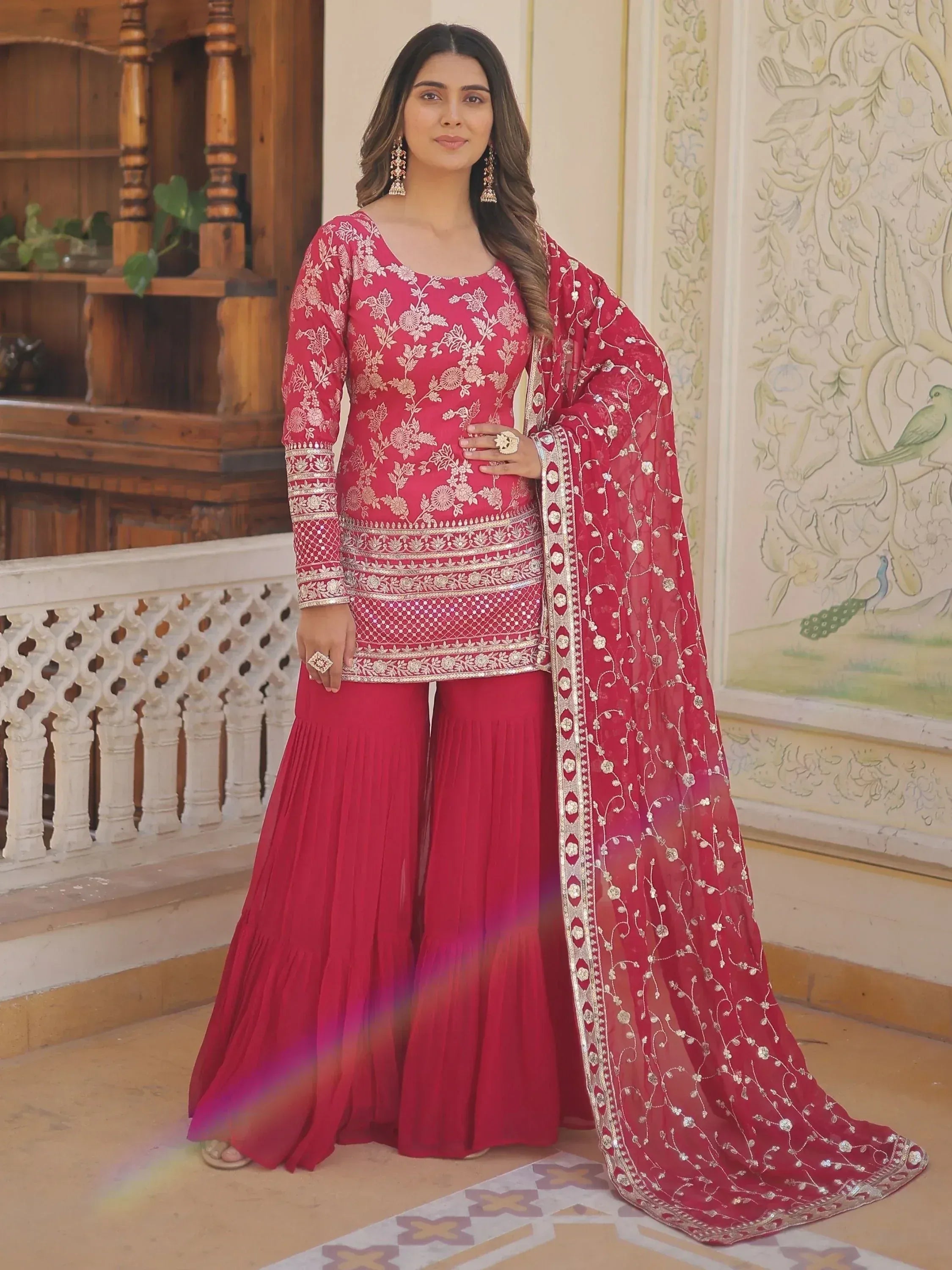 Elegant red embroidered salwar kameez with floral designs and matching dupatta, perfect for ethnic occasions.