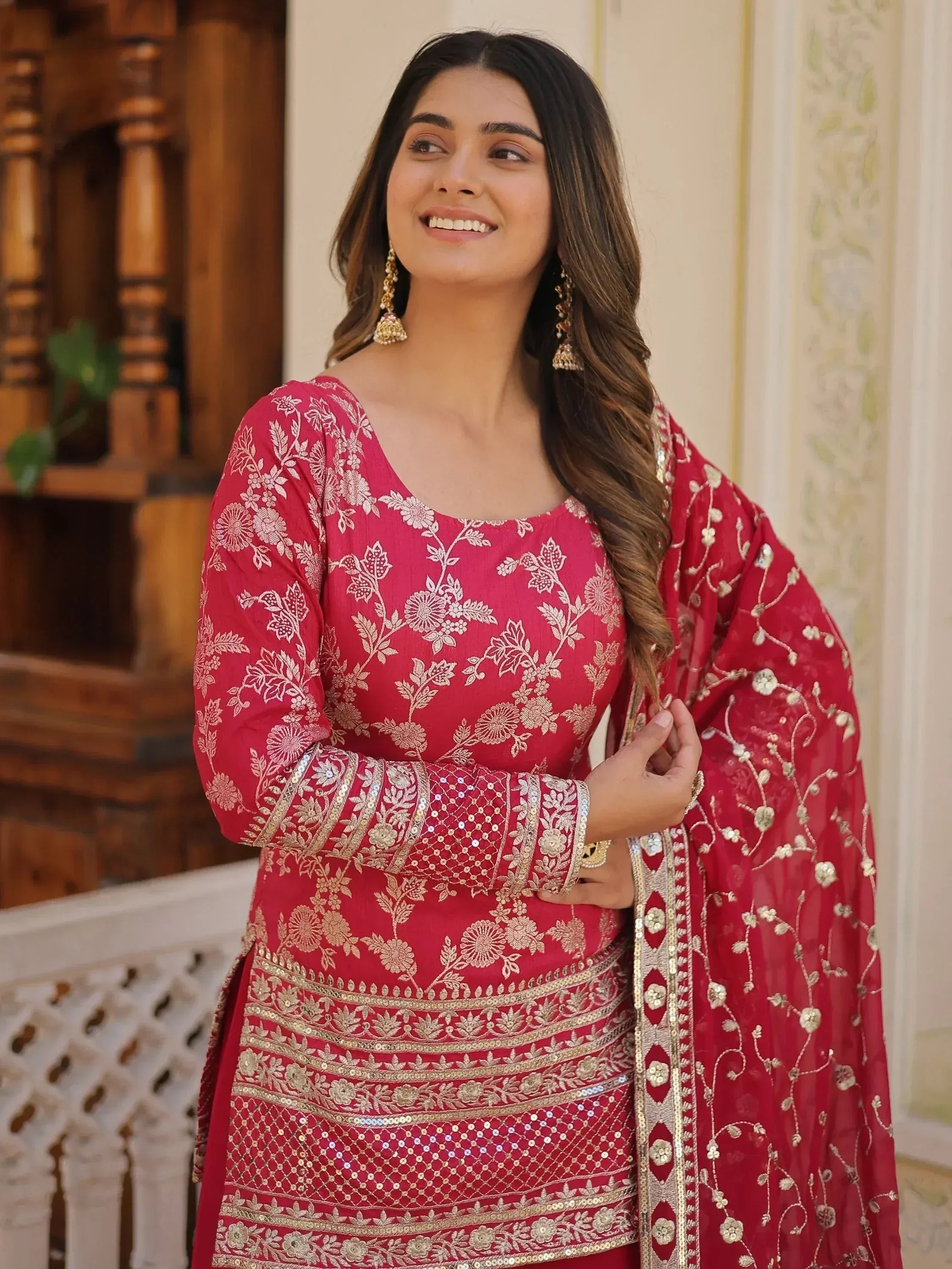 Red embroidered salwar kameez with gold floral work, perfect for Indian ethnic wear occasions.