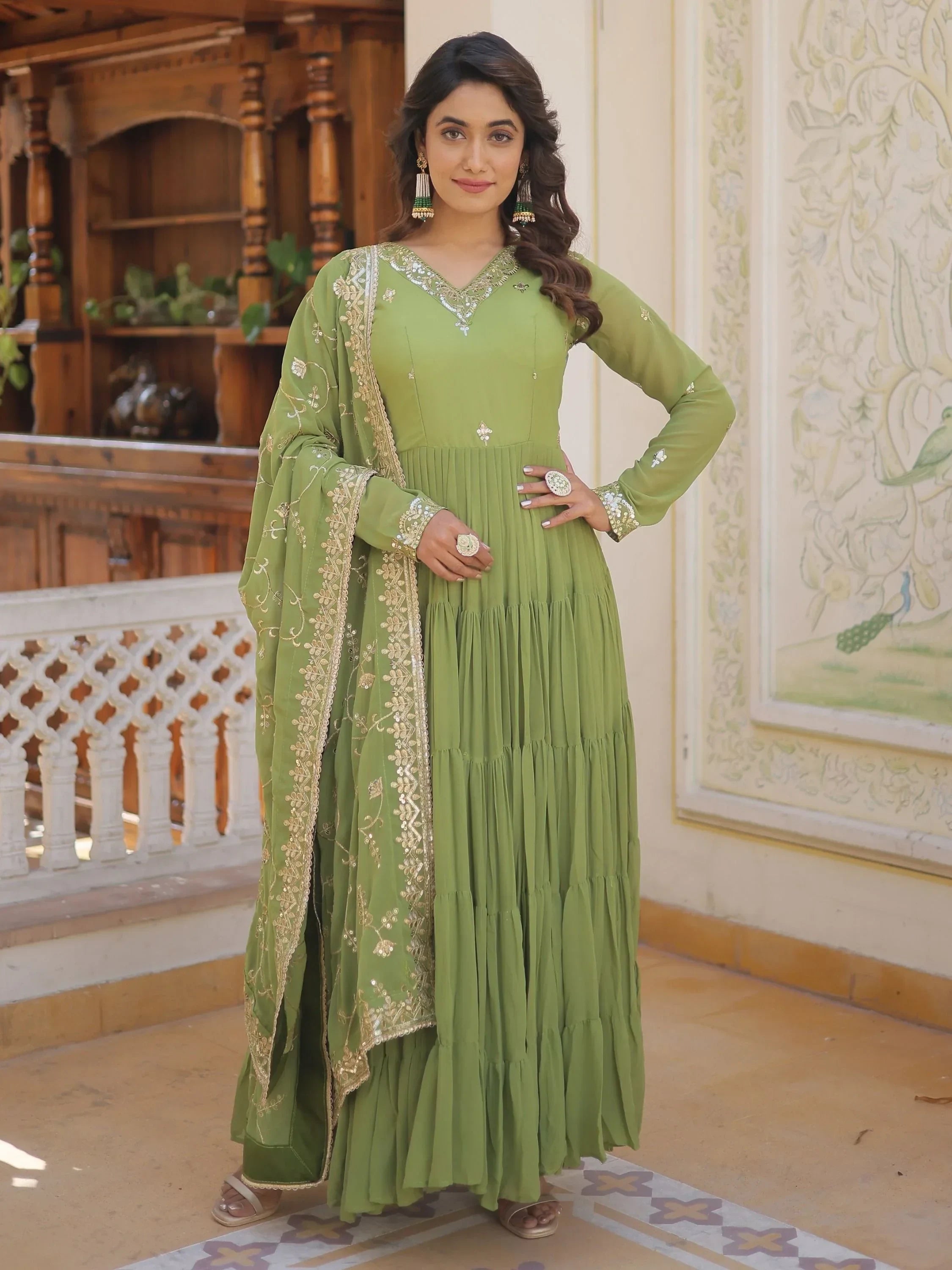 Woman in olive green Anarkali gown with gold embroidery and matching dupatta, Indian ethnic wear